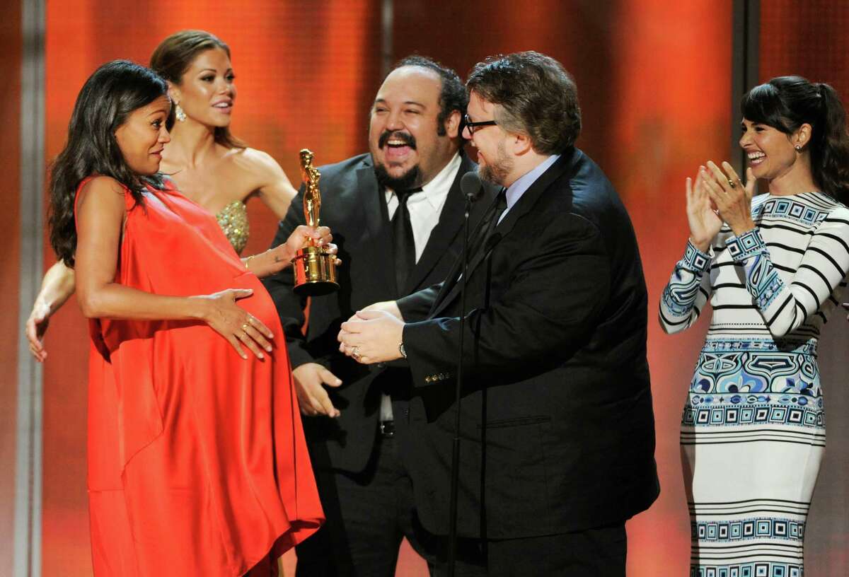 Zoe Saldana, left, Jorge R. Gutierrez, center, and Mia Maestro, right, present Guillermo Del Toro, second from right, with the Anthony Quinn award for excellence at the NCLR ALMA Awards at the Pasadena Civic Auditorium on Friday, Oct. 10, 2014, in Pasadena, Calif. (Photo by Chris Pizzello/Invision/AP)