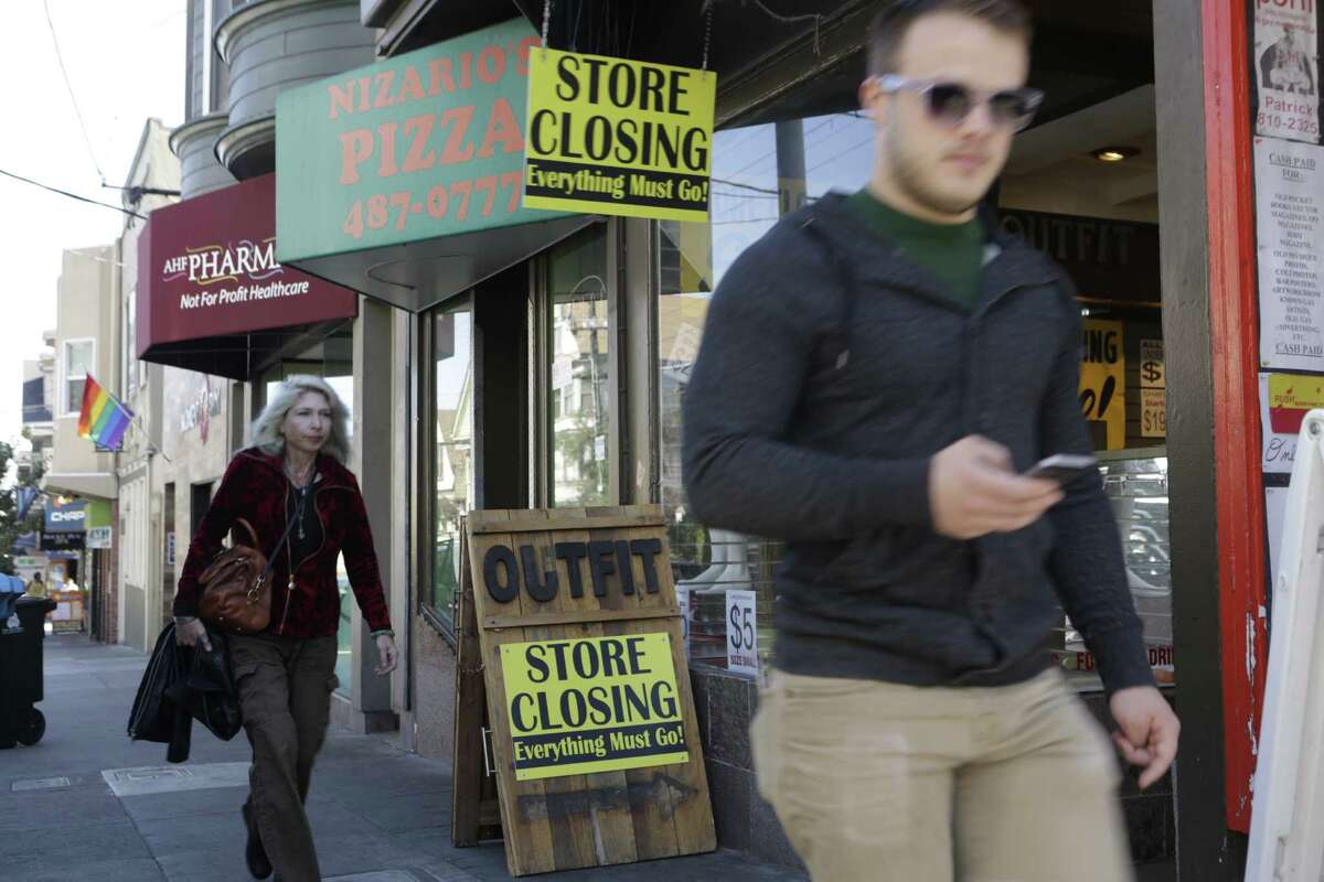 Pedestrians walk past the Outift clothing store on 18th Street in San Francisco on Friday, October 10, 2014. Outfit is moving to new, larger location, just around the corner on Castro Street.