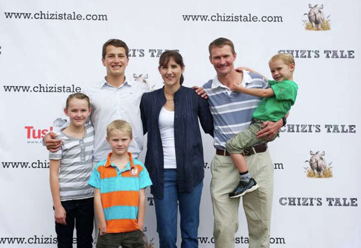 Greenwich's Jack Jones poses with the family, the Wenham's, who inspired his book "Chizi's Tale."