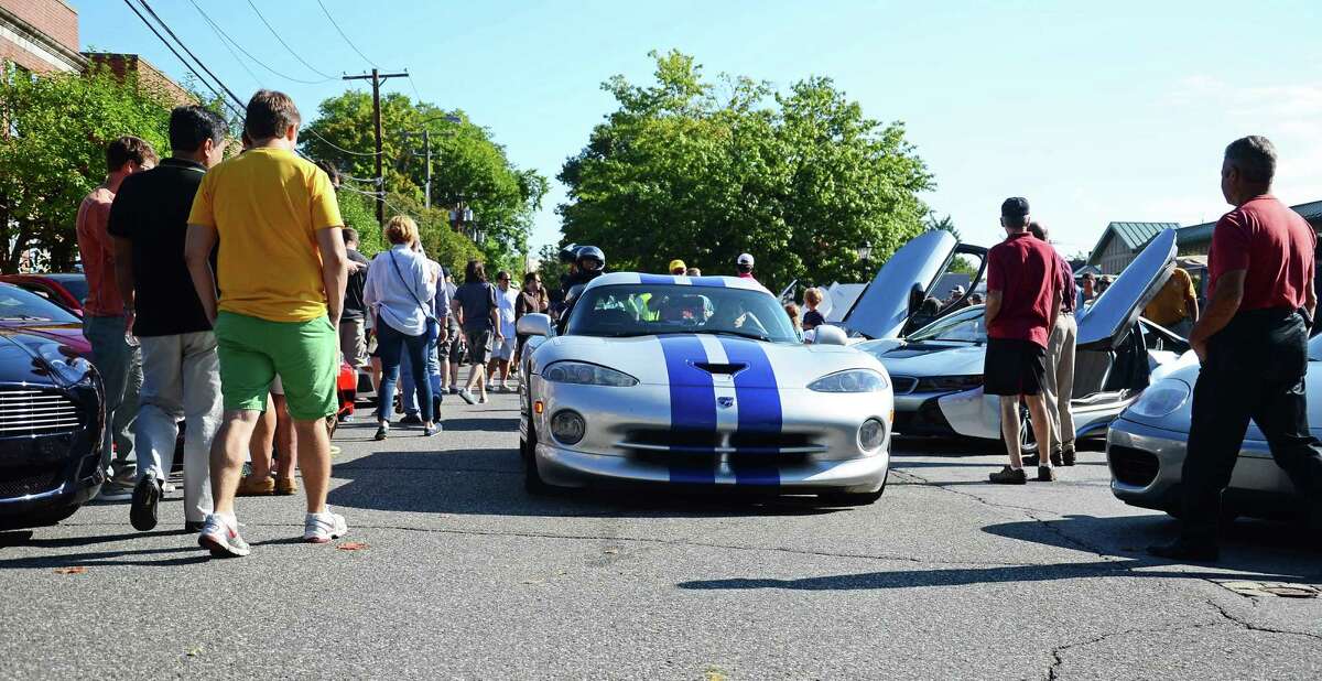 Hundreds of unique cars roll into downtown New Canaan, Conn., during Caffeine & Carburetors Sept. 7, 2014. For the first time this Sunday, Oct. 19, the increasingly popular event will be taking place at Waveny Park.