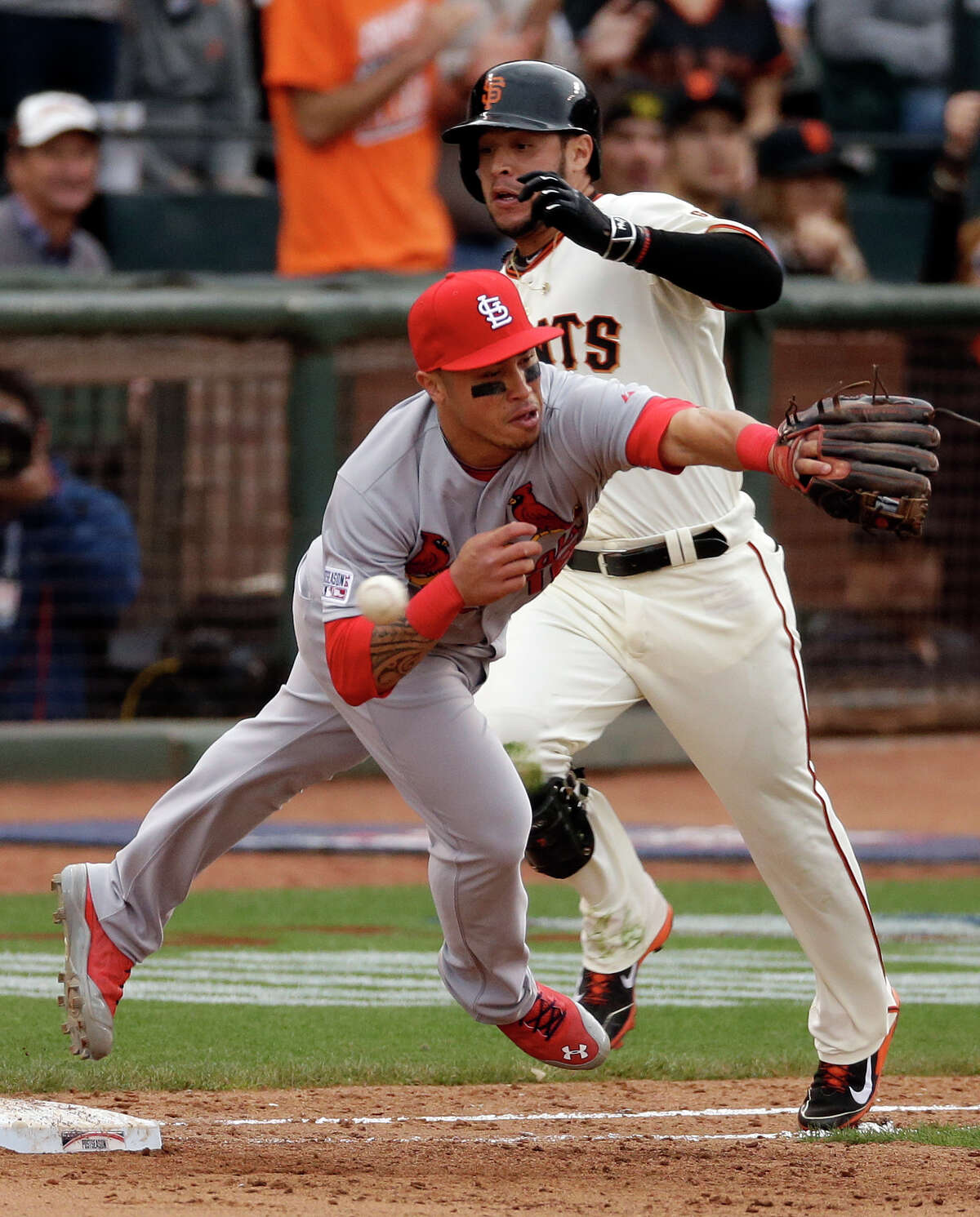 Kolten Wong can't reach Cardinals pitcher Randy Choates's errant throw after a bunt by Gregor Blanco, allowing the Giants to score the winning run in the 10th.