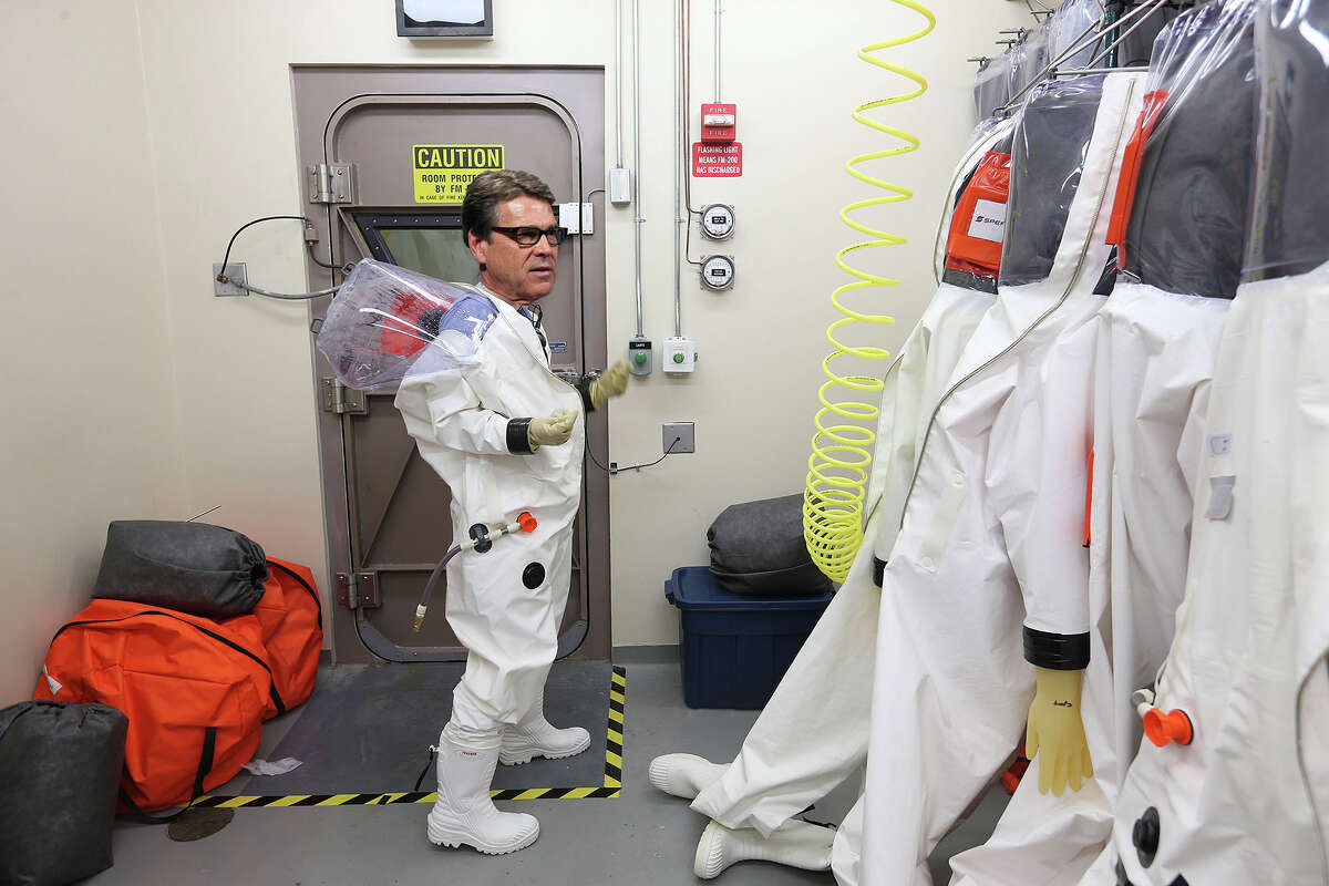 Ebola Perry: The governor has been quick to show that he is on top of the Ebola situation in Texas. "Suit me up! I'm going in, mofos!" The news that inspired this costume: Perry visits Fort Hood troops deploying to Liberia (original photo: San Antonio Express-News, Perry photo: Rodolfo Gonzalez/AP)
