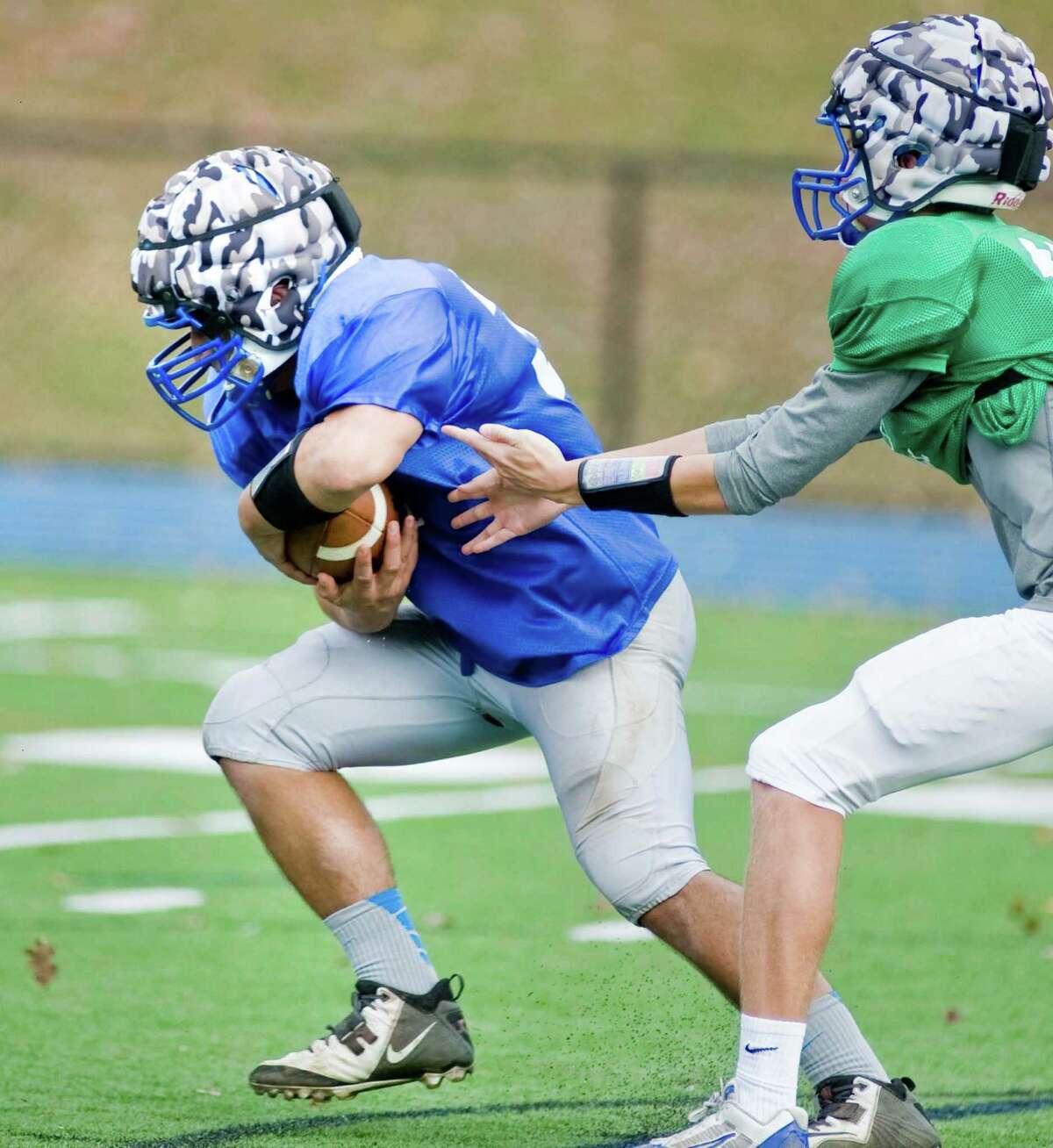Nick Rubino takes the handoff during a Newtown High School football practice. Wednesday, Oct. 15, 2014