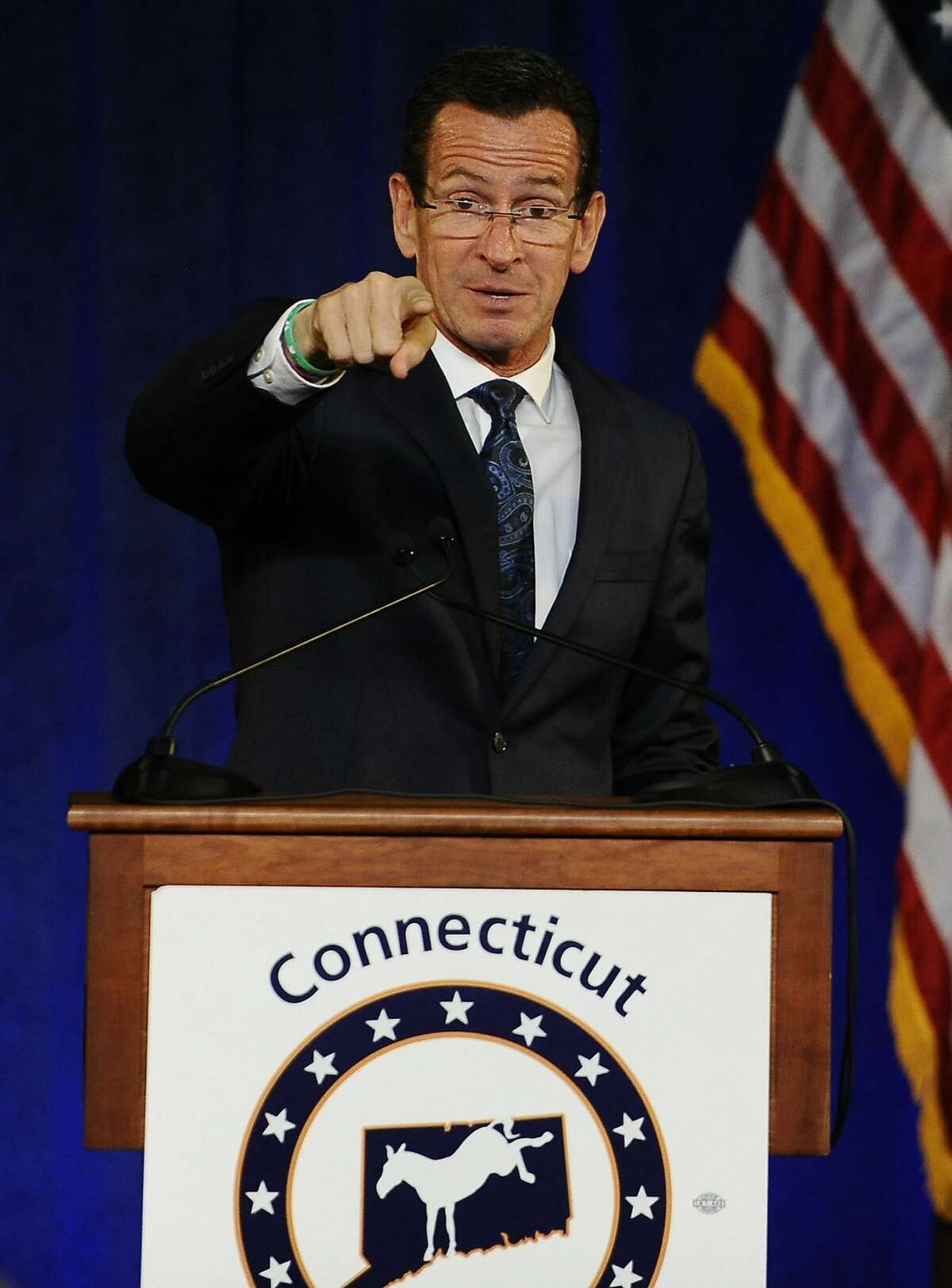 Gov. Dannel P. Malloy points at a rally with former President Bill Clinton, Monday, Oct. 13, 2014, in Hartford, Conn. (AP Photo/Jessica Hill)