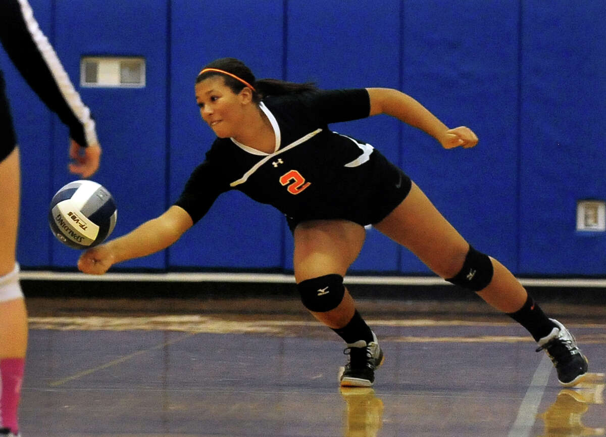 Shelton's Samantha Stevens tries to bump the ball back to the Lauralton Hall side, during girls volleyball action in Milford, Conn. on Wednesday October 15, 2014.