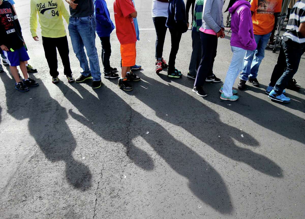 Middle school students lined up on the playground after the drill for a speech by Mayor Lee Thursday October 16, 2014. The great California "Shakeout" was observed at Marina Middle School in San Francisco, Calif. with an earthquake drill for students and some public officials.