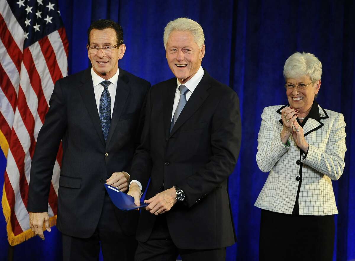 Gov. Dannel P. Malloy, left, greets former President Bill Clinton, center, as Lt. Gov. Nancy Wyman looks on, at a rally, Monday, Oct. 13, 2014, in Hartford, Conn. (AP Photo/Jessica Hill)
