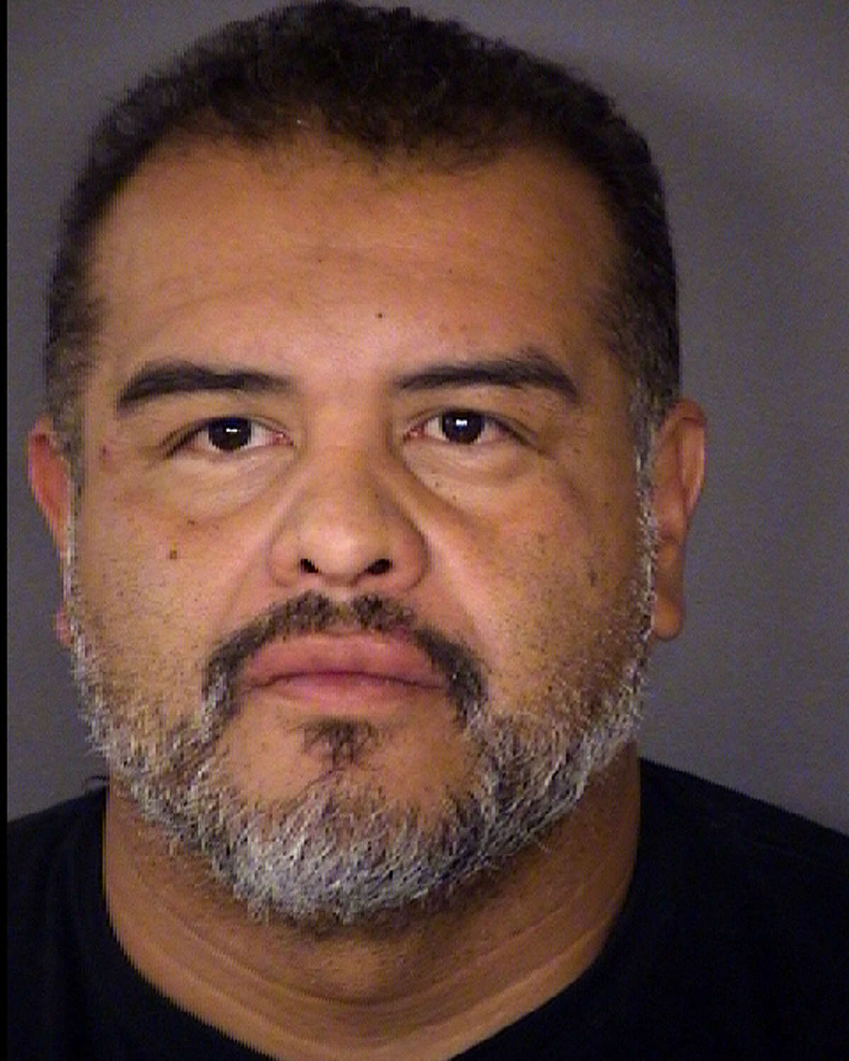 David Angel Esquivel, 47, is accused of starting a fire in a house while eight others were inside.