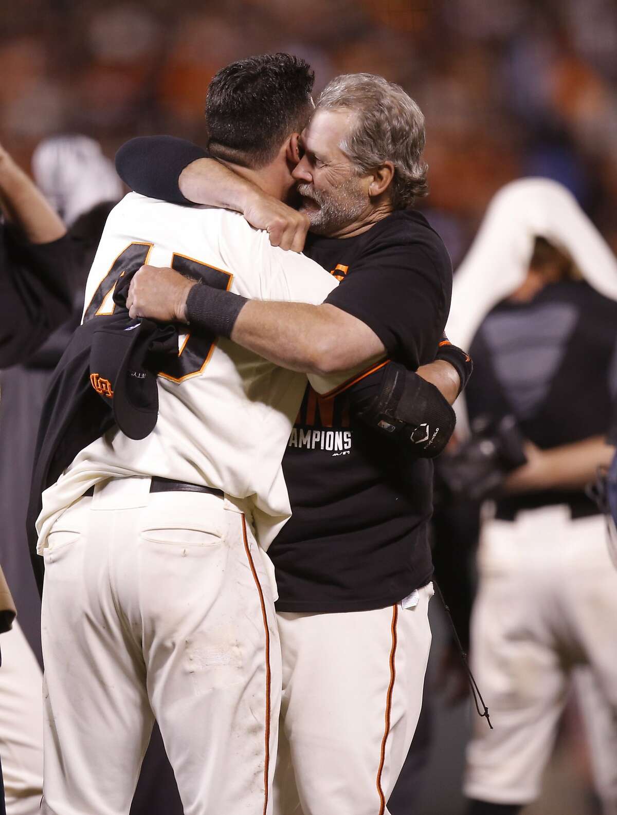 Bullpen catcher Bill Haye embraces Travis Ishikawa after the Giants defeated the Cardinals 6 to 3 in Game 5 of the NLCS at AT&T Park on Thursday, Oct. 16, 2014 in San Francisco, Calif.