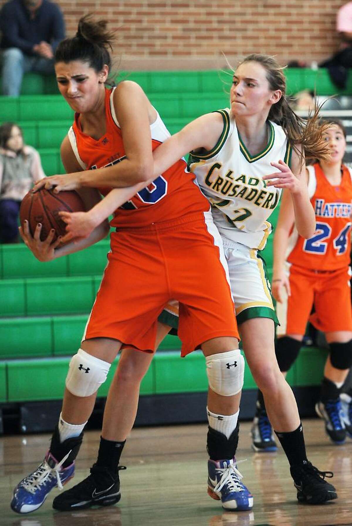 Trinity Catholic's Cayleigh Griffin battles for control of the ball with Danbury's Casey Smith in the quarterfinals of the FCIAC girls basketball championship in Stamford, Conn. on Saturday, Feb. 20, 2010.