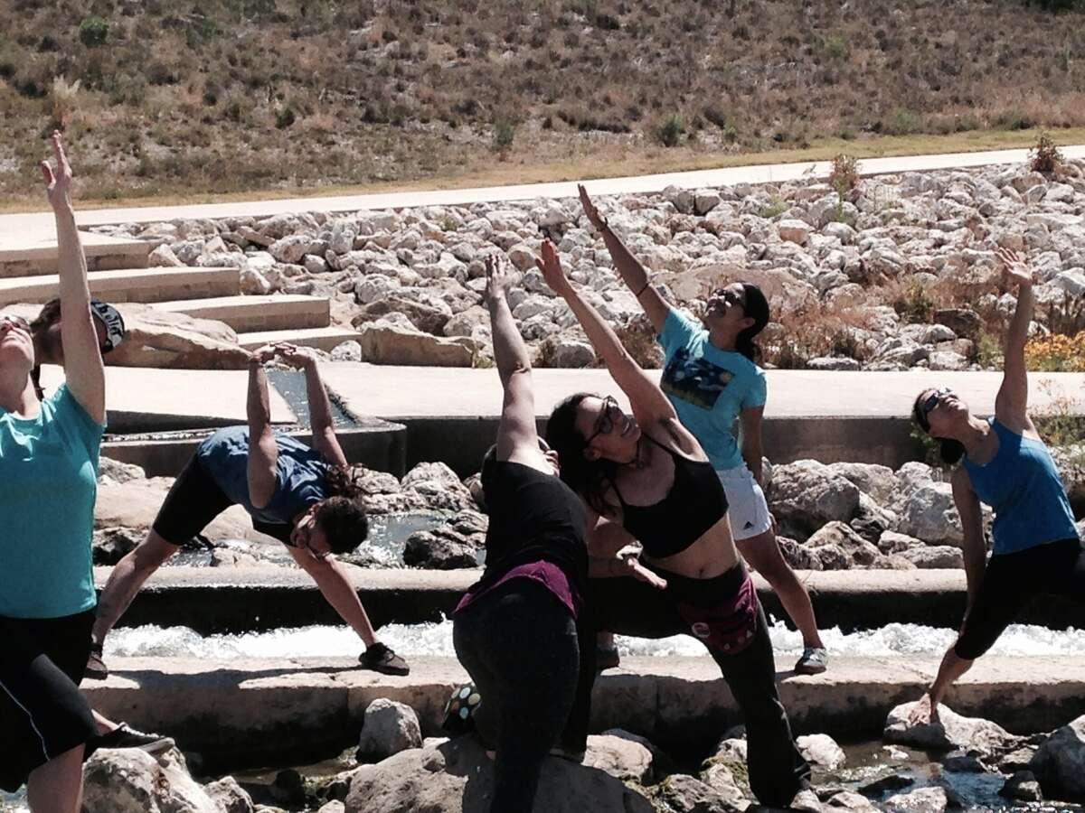 Monica Walker holds yoga classes along the San Antonio River on Saturday mornings.
