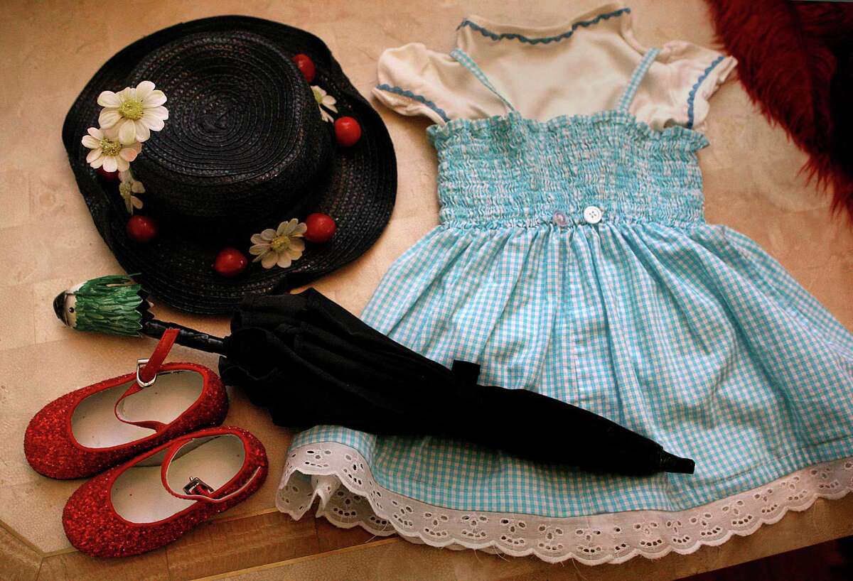 Parts of Ava Vukic’s first costumes worn as a child. The hat and umbrella are from the Mary Poppins costume, and the dress and shoes are from the Dorothy (Wizard of Oz) costume.