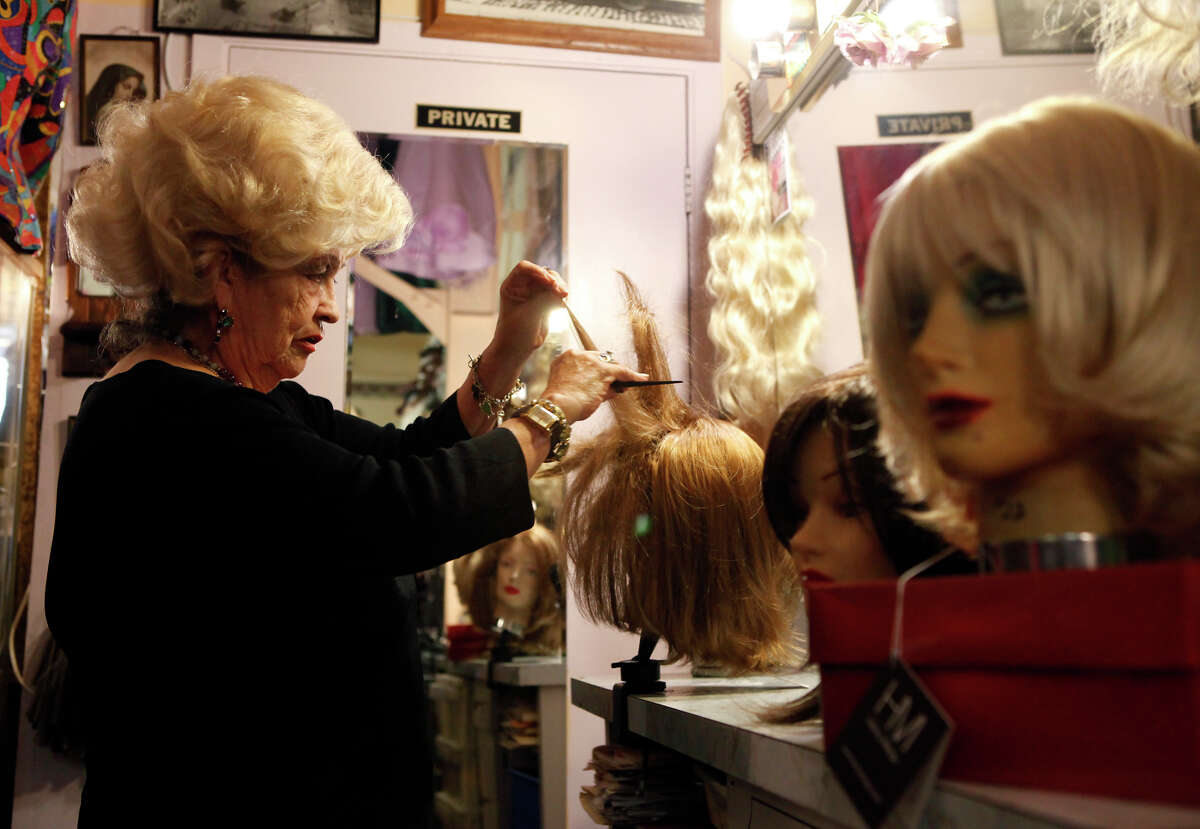 Rosalie Jacques shows how to back-comb a wig at Gypsy Rosalie’s Wigs and Vintage shop on Polk Street in S.F. The wig maker, known for “big hair,” says Halloween and Gay Pride are the busiest times.