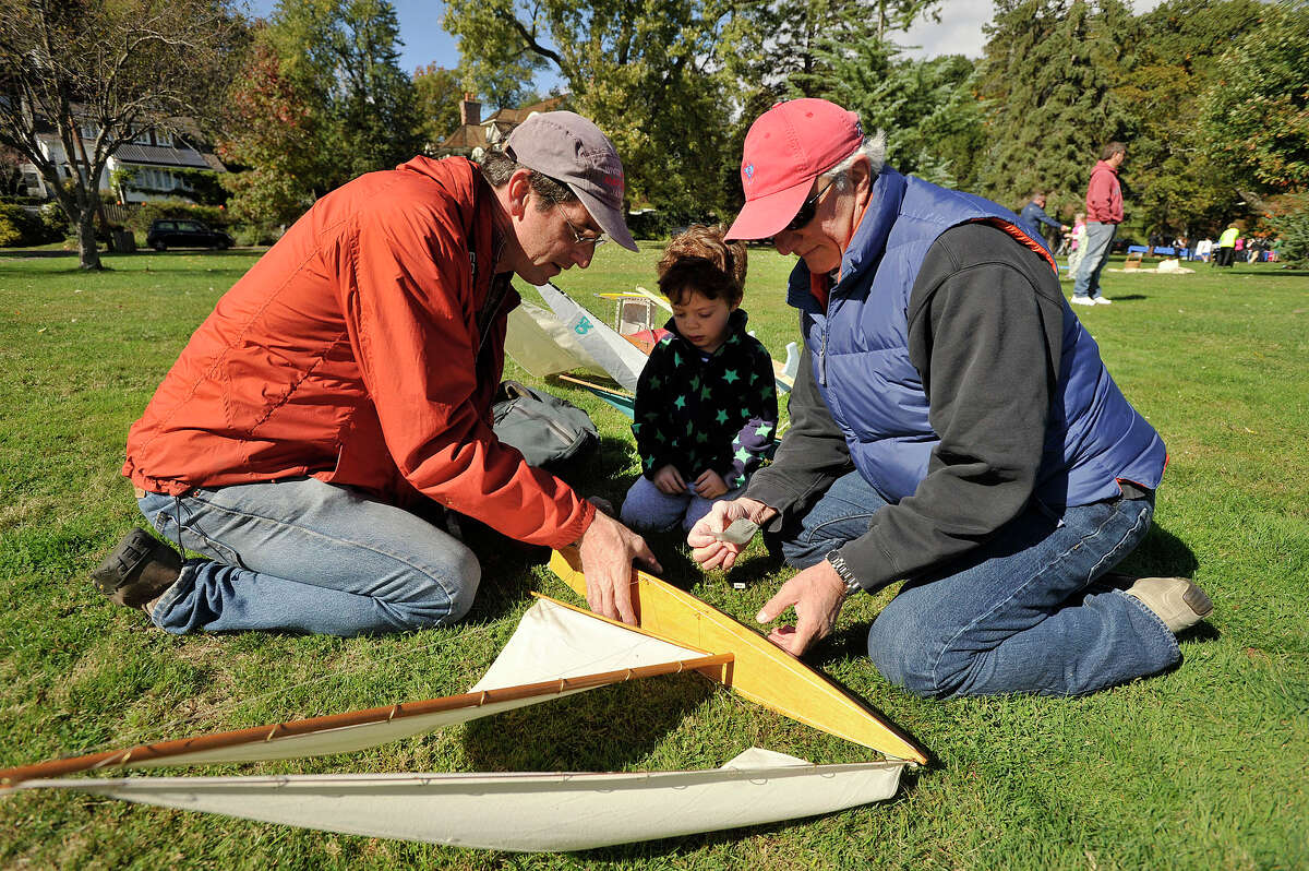 Steve O'Brien, left, Ramze Zakka, right, and Ramze's son, Christian work on Zakka's boat prior to the start of the 51st annual Old Greenwich-Riverside Community Center Sailboat Regatta at Binney Park in Greenwich, Conn., on Sunday, Oct. 19, 2014.