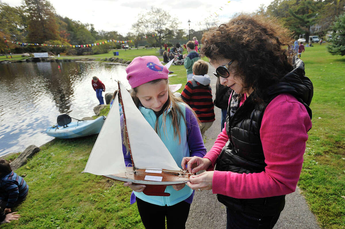 Carol Zelenz helps her daughter, Marina Zelenz, prepare her sailboat prior to the start of the 51st annual Old Greenwich-Riverside Community Center Sailboat Regatta at Binney Park in Greenwich, Conn., on Sunday, Oct. 19, 2014.