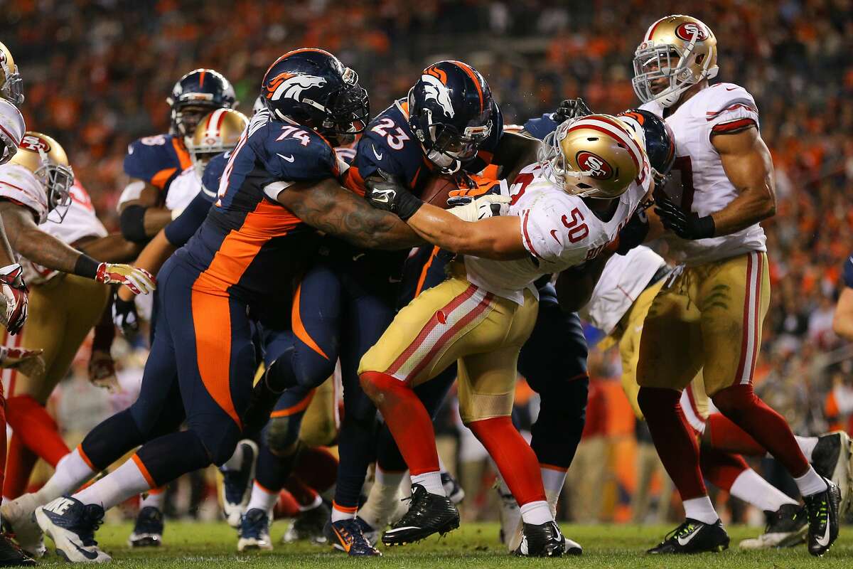 DENVER, CO - OCTOBER 19: Running back Ronnie Hillman #23 of the Denver Broncos pushes inside linebacker Chris Borland #50 of the San Francisco 49ers as he has a 1-yard rushing touchdown with the help of guard Orlando Franklin #74 during the third quarter of a game at Sports Authority Field at Mile High on October 19, 2014 in Denver, Colorado. (Photo by Justin Edmonds/Getty Images)