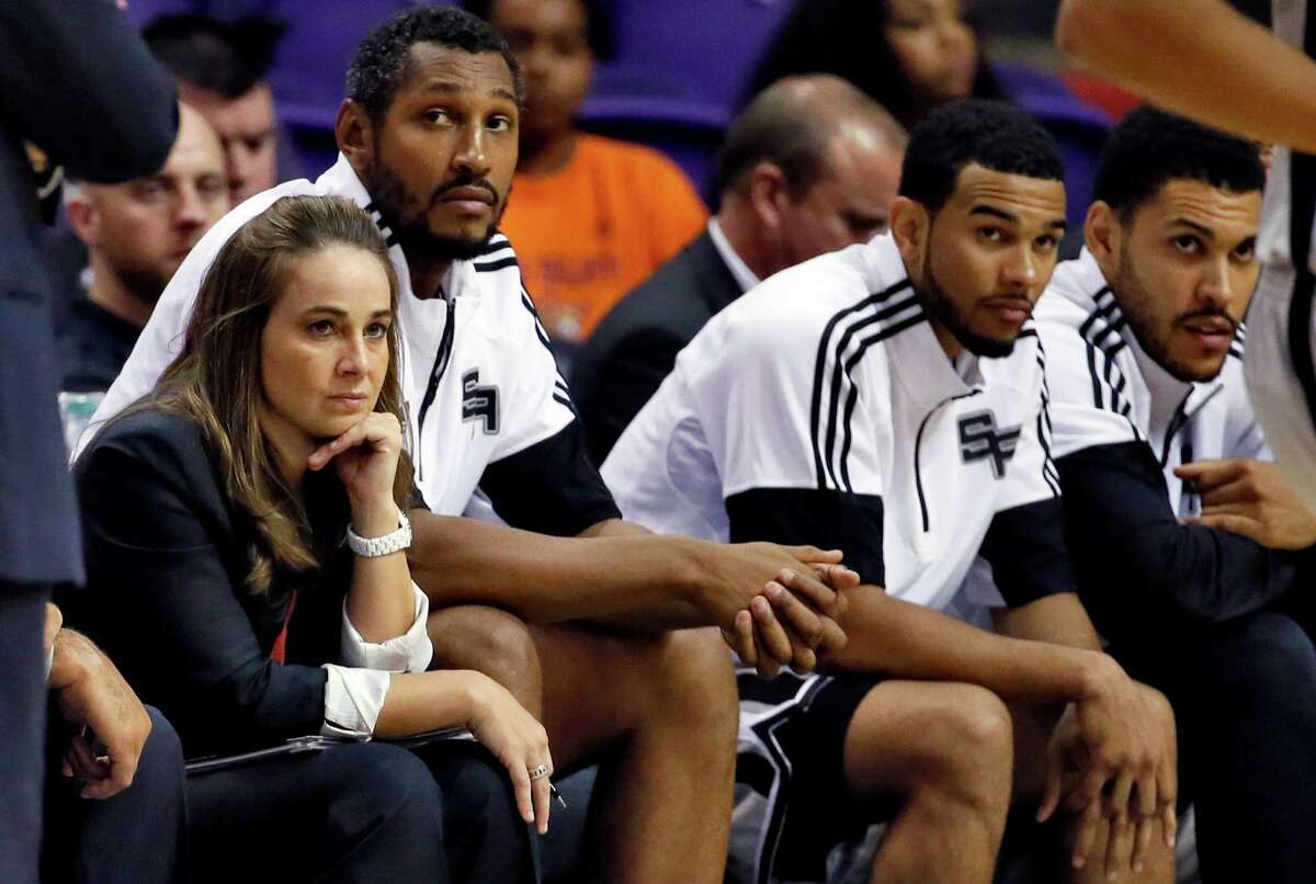 San Antonio Spurs assistant coach Becky Hammon watches during the second half of a preseason game against the Phoenix Suns. A reader says that if Hammon has input on the types of plays the Spurs run, it will shatter at least one stereotype about men.