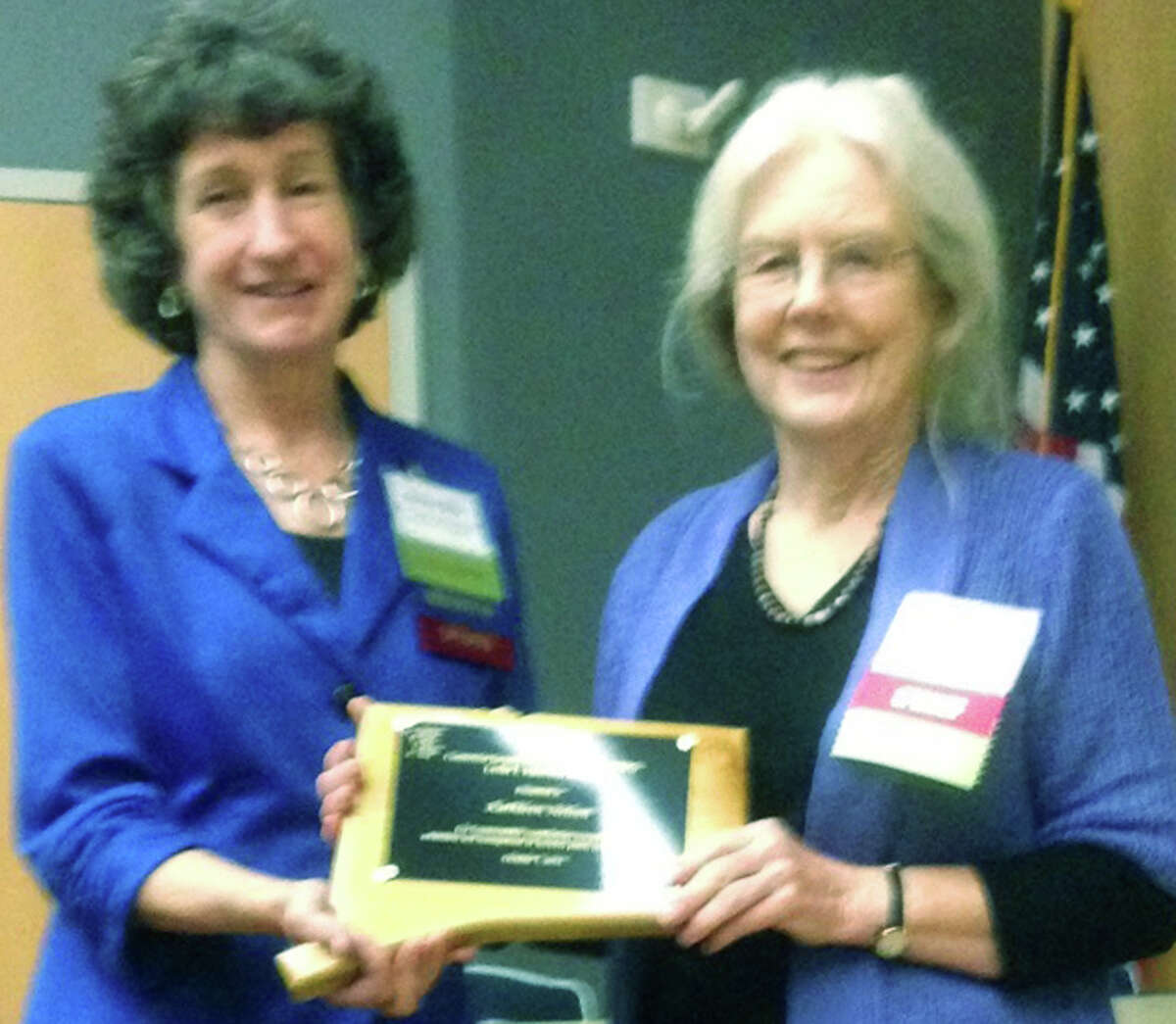 Kathleen Nelson, right, of New Milford receives the Les Mehrhoff Award from Donna Ellis during the Connecticut Invasive Working GroupâÄôs annual meeting recently at the University of Connecticut in Storrs. October 2014 Courtesy of Bob Gambino