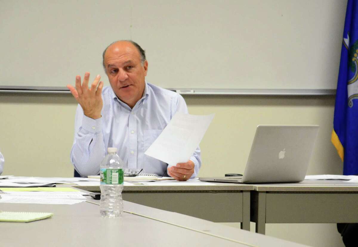 Police Commission Chairman Stuart Sawabini discusses the possibility of installing parking meters on Elm Street during a meeting at the New Canaan Police Department, New Canaan, Conn., Wednesday, Oct. 15, 2014.