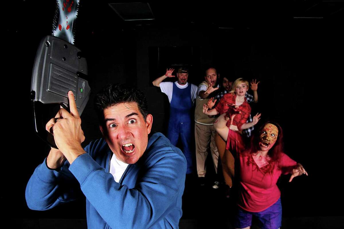 Steve Garris plays chainsaw-toting Ash, who has his hands full from characters played by Brennan Blankenship, right front, Sydney Blankenship, Benjamin Arredondo, Alex Cochrane and Kevin Blankenship in Pearl Theater's "Evil Dead: The Musical."