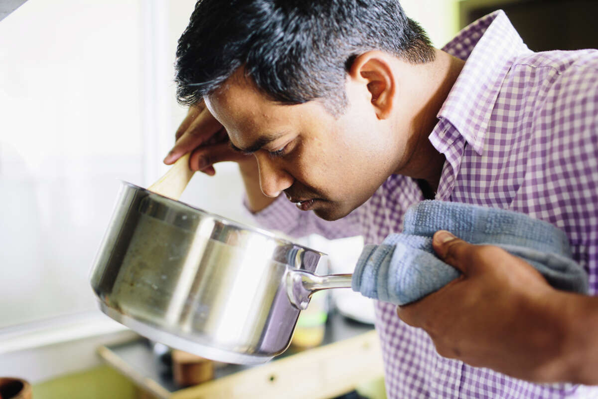 Gopinathan checks on the korma, a traditional Indian braise, at his home in San Francisco.