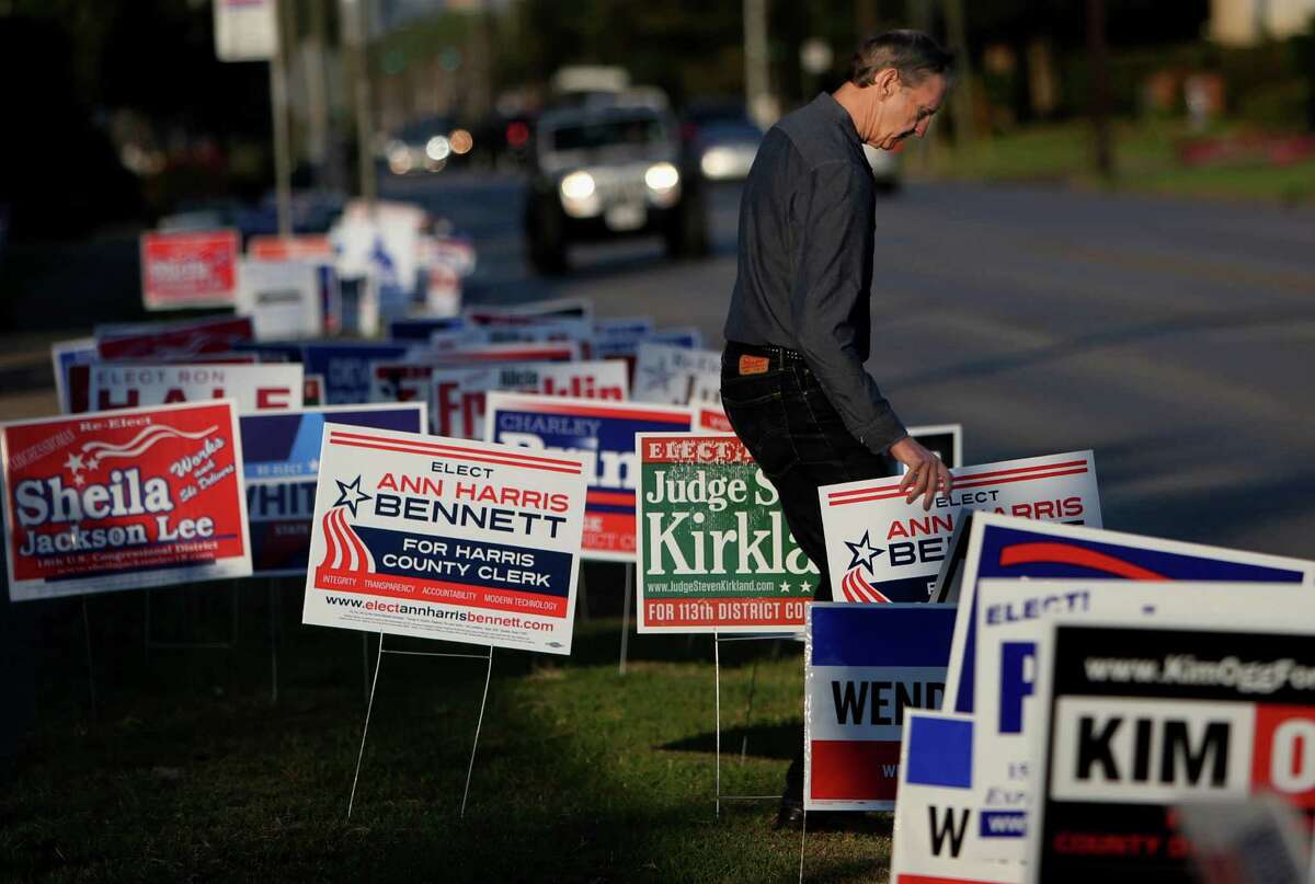 Robert Downs places yard signs for candidate Ann Harris Bennett at early voting at State Representative District 134M at the Metropolitan Multi Service Center on West Gray Monday, Oct. 20, 2014, in Houston, Texas. ( Gary Coronado / Houston Chronicle )