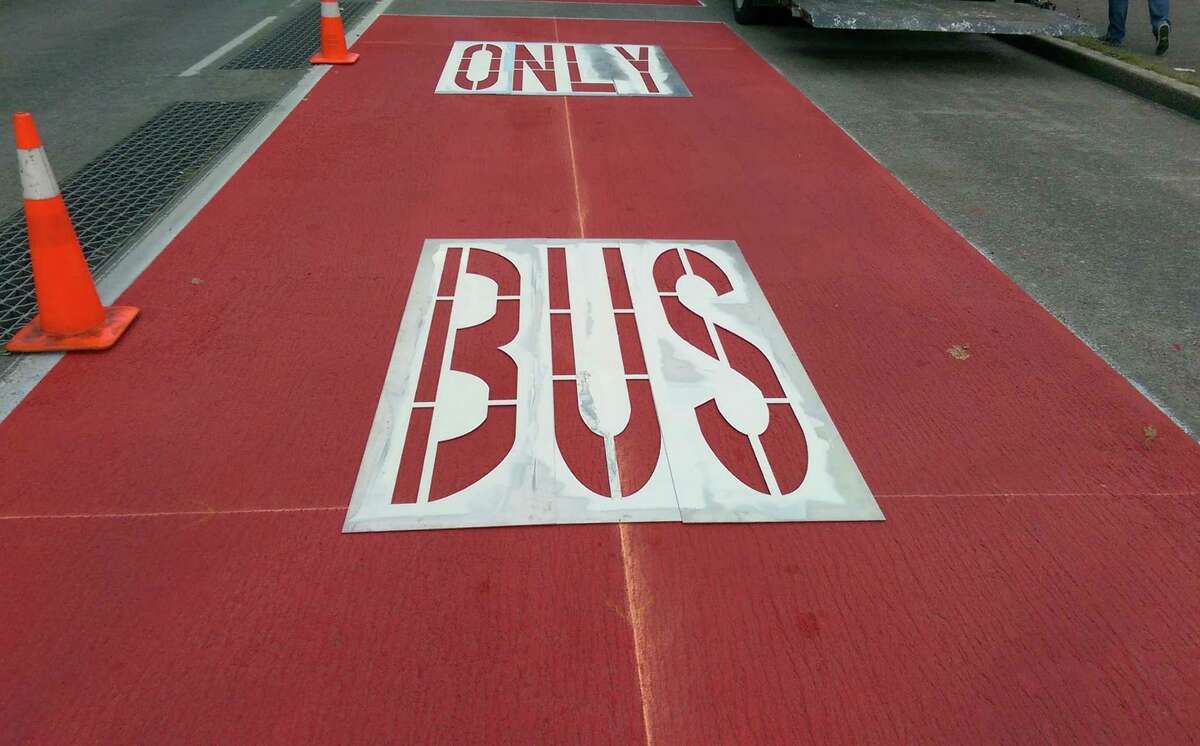 A stencil awaits spray painting on new "Bus Only" markings on Battery Street in Belltown on Tuesday, Oct. 21, 2014.