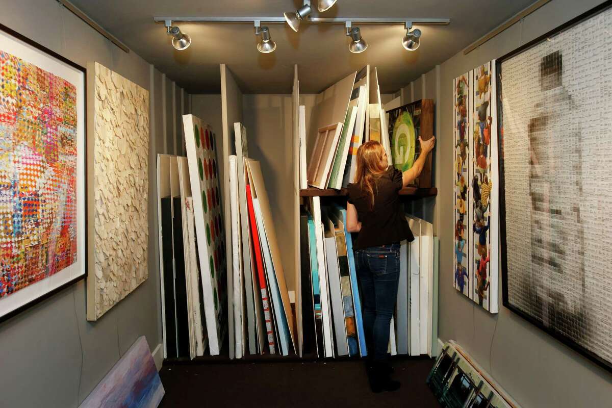 Stephanie Breitbard looks over stored art pieces in the smaller outside gallery of her Mill Valley home.