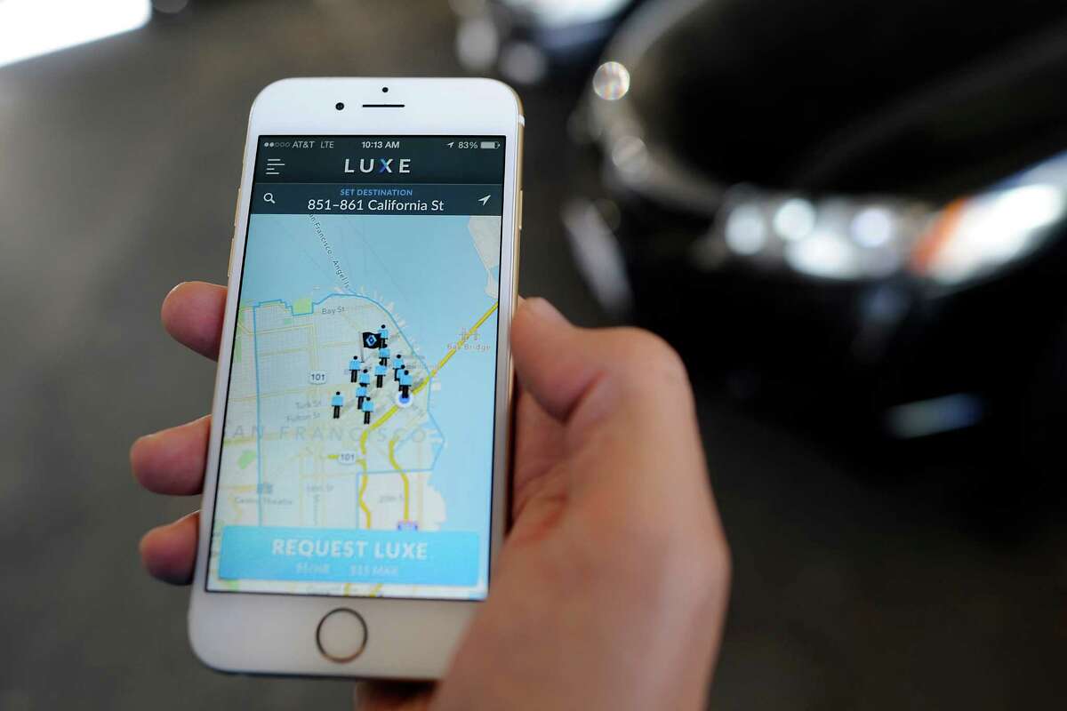 Valet Josh Dunlap show the iPhone app for on-demand valet service Luxe Valet in San Francisco on Oct. 22, 2014. Luxe Valet allows customers to summon a valet with an iPhone app, and the valet meets them wherever they want and drives the car to a secure lot.