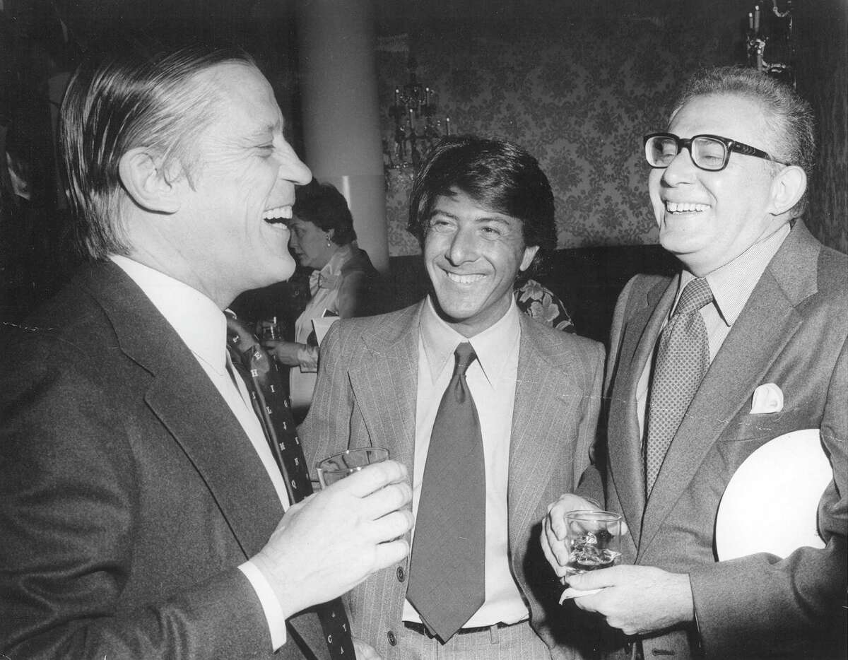 At the Kennedy Center reception before the premiere of "All the President's Men." Dustin Hoffman tells a very funny, dirty joke to Ben Bradlee and Harry Rosenfeld, who appreciated the actor's sense of humor. (The Washington Post)