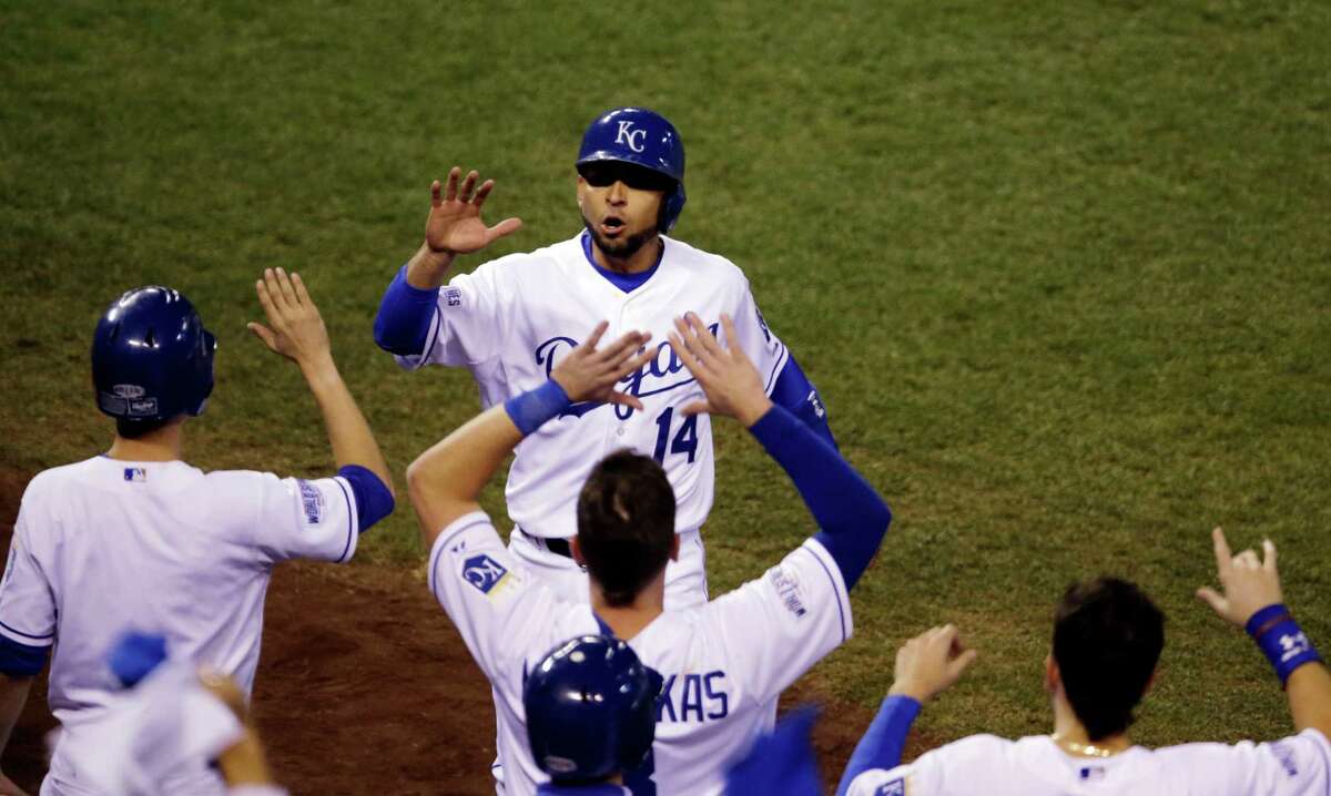 Kansas City Royals' Omar Infante celebrates with teammates after scoring a run during the second inning of Game 2 of baseball's World Series against the San Francisco Giants Wednesday, Oct. 22, 2014, in Kansas City, Mo. (AP Photo/Jeff Roberson)