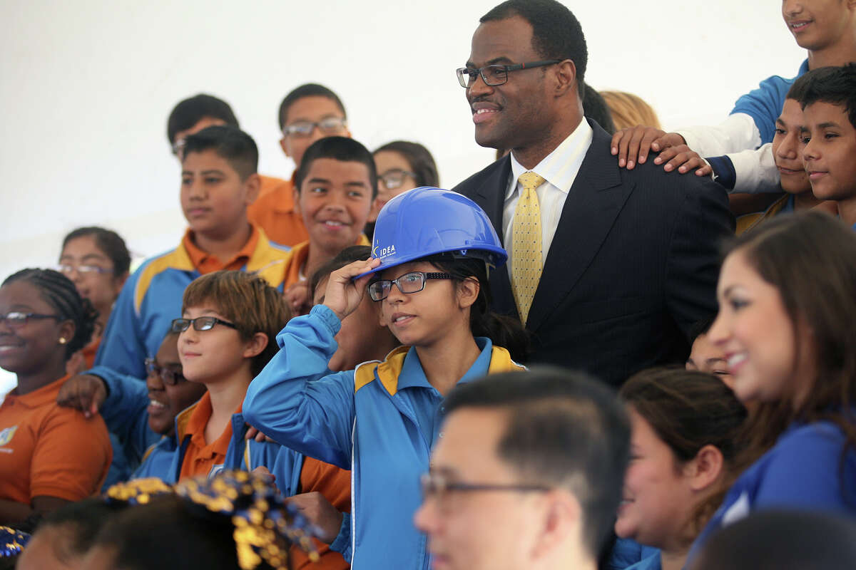 David Robinson takes photos with IDEA Carver Academy students including Yaletsi Guerrero who wore Robinson's hardhat Oct. 22, 2014 after the groundbreaking ceremony of IDEA Carver College Prep finished behind the existing IDEA Carver Academy where construction is under way for a gymnasium as well.Carver Academy was founded by Robinson in 2012 and the new school will include a David Robinson Museum. IDEA Carver College Prep will be facing Commerce Street. IDEA Public Schools currently has 8 schools in San Antonio with more than 2200 students and about 650 of those at Carver Academy. According to Sam Goessling, chief advancement officer for IDEA Public Schools, IDEA is planning on having 20 schools in San Antonio by the 2017-2018 school year.