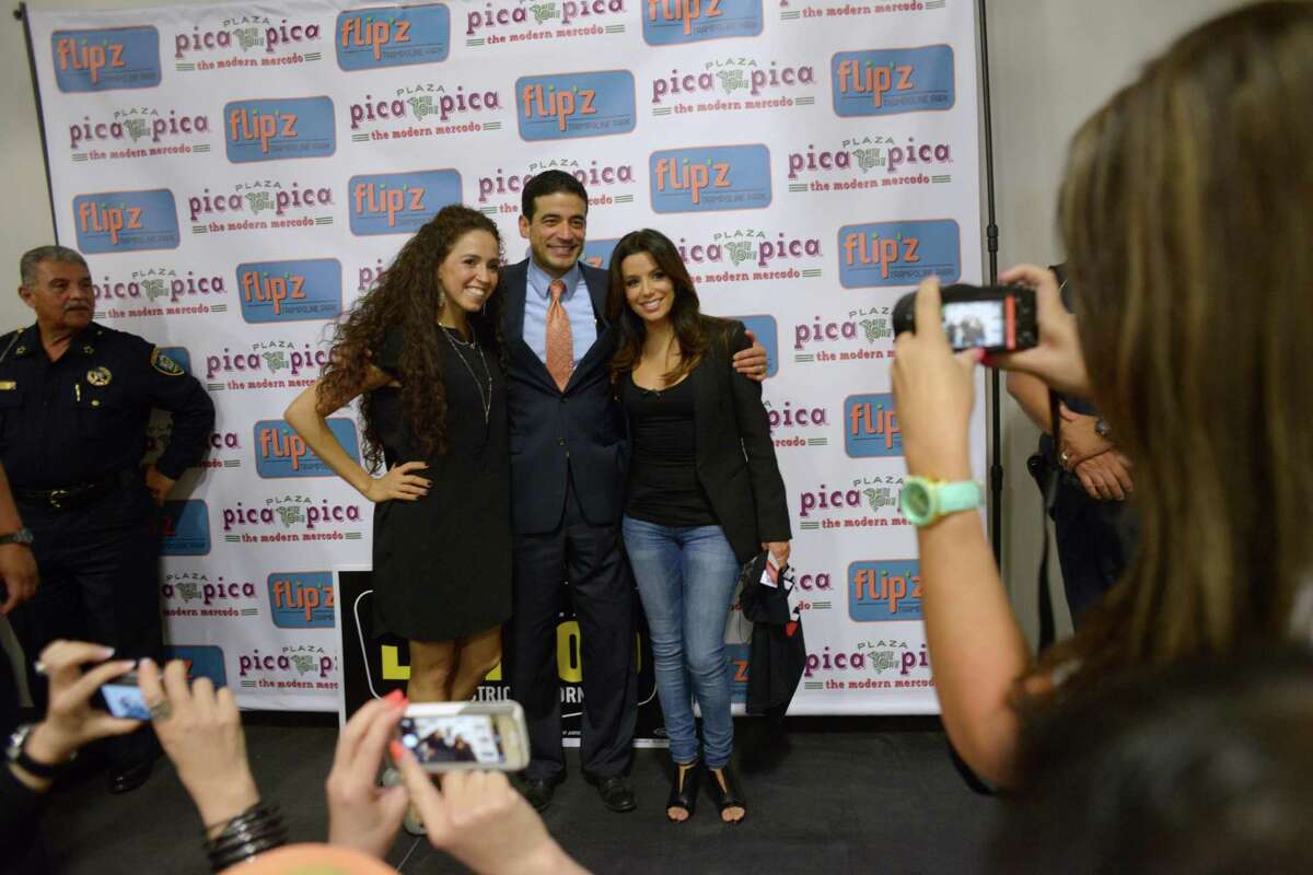 Actress and producer Eva Longoria, right, joins Nicholas LaHood, Democratic candidate for district attorney, and his wife Davida onstage at Plaza Pica Pica on the Southside on Wednesday, Oct. 22, 2014.