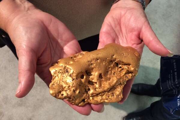 The 6.07-pound gold “Butte Nugget” is held in San Francisco on Oct. 23, 2014.