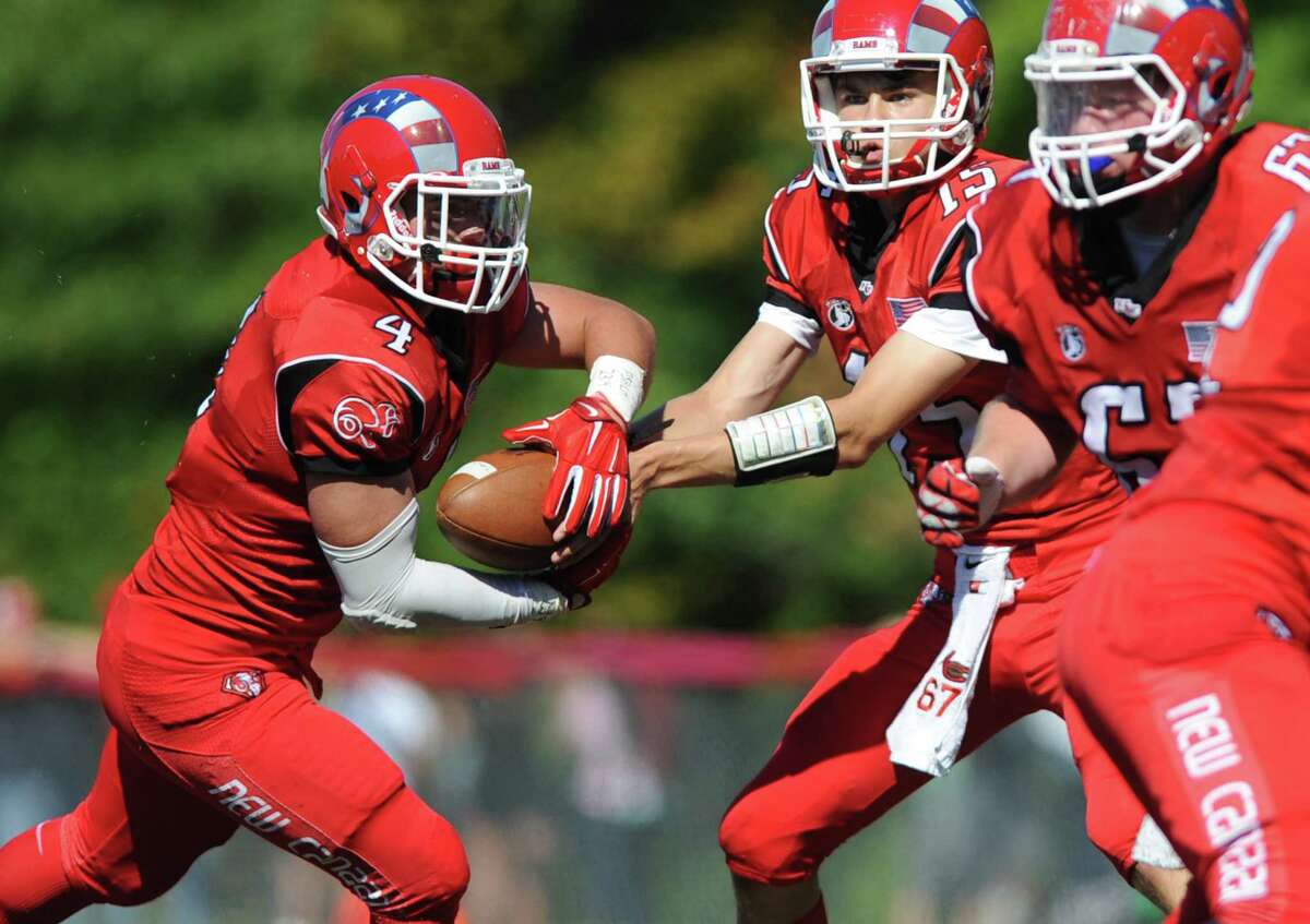 New Canaan QB Mike Collins hands off to RB Frank Cognetta.