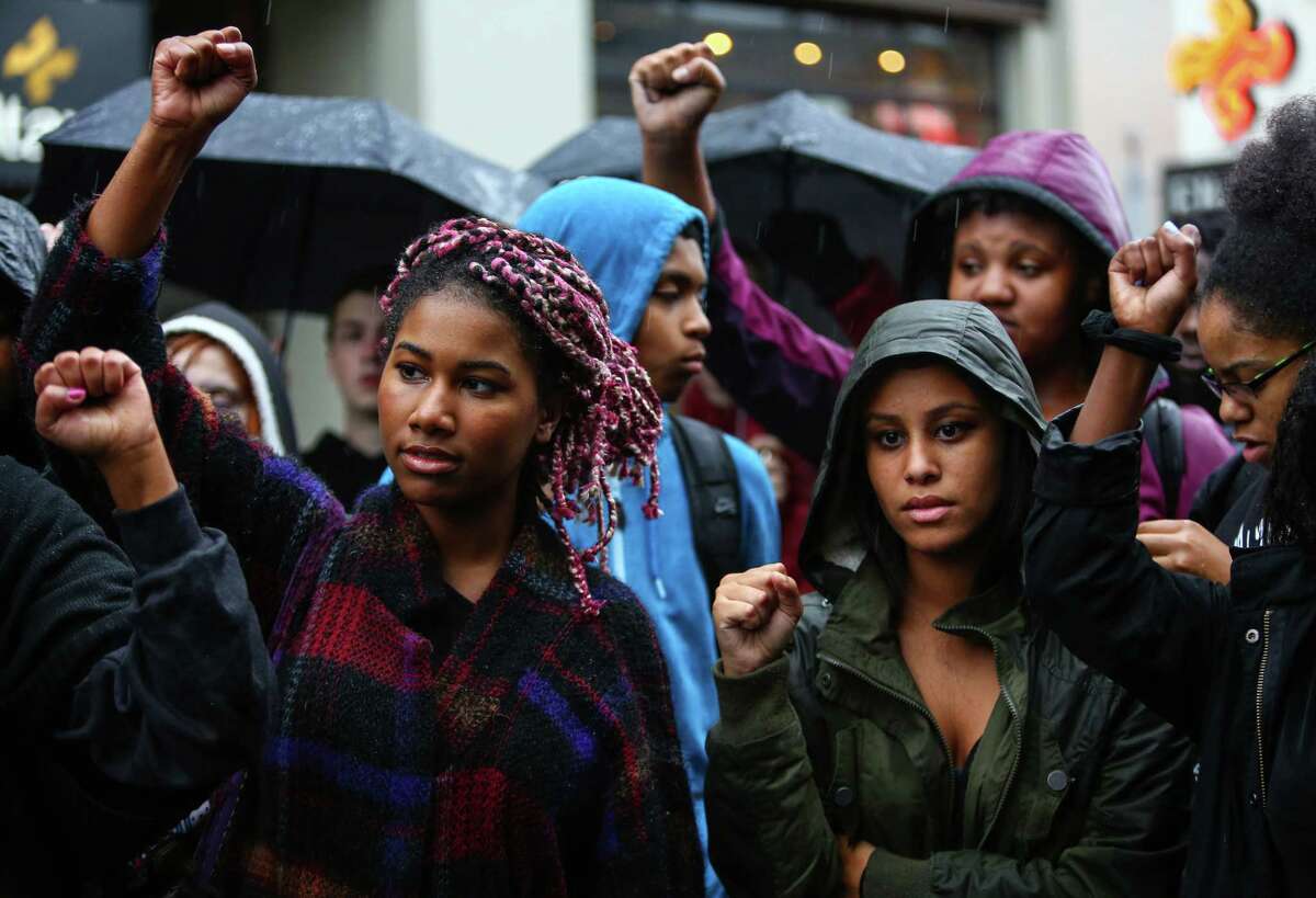 Students affiliated with the Garfield High School Black Student Union gather at the Seattle Police Department's East Precinct after a march there from the school. The young marchers were calling for an end to police brutality. Photographed on Wednesday, October 22, 2014.