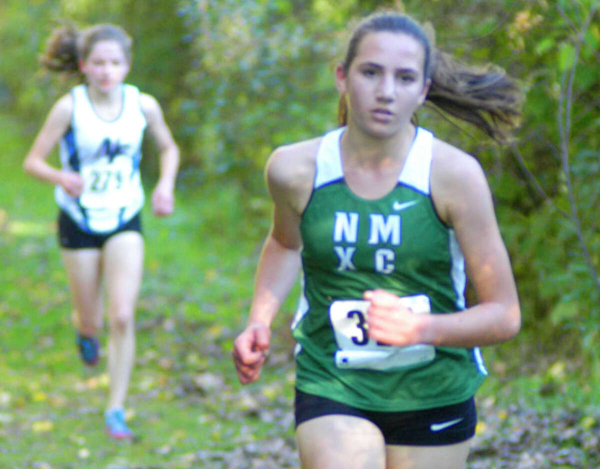 Green Wave sophomore Mia Nahom maintains a 20-yard lead on eventual champion Gabrielle Richichi as they climb The Beast just past midway in the Oct. 17, 2014 South-West Conference girls' cross country race at Bethel High School.