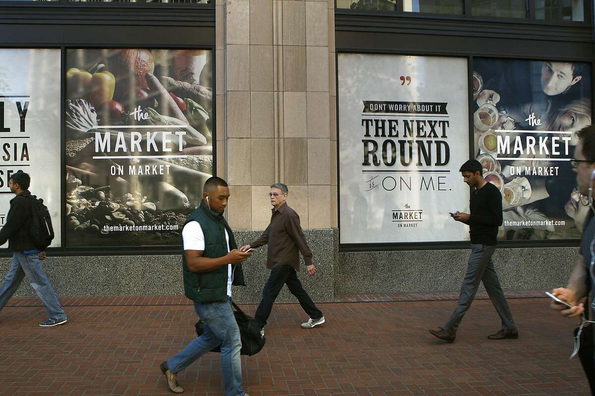 Pedestrians walk outside the new locally owned grocery store named Market on Market on the first floor of the Twitter building in San Francisco, Calif., on Thursday, October 23, 2014. Under construction Market on Market is scheduled to open by the holidays.