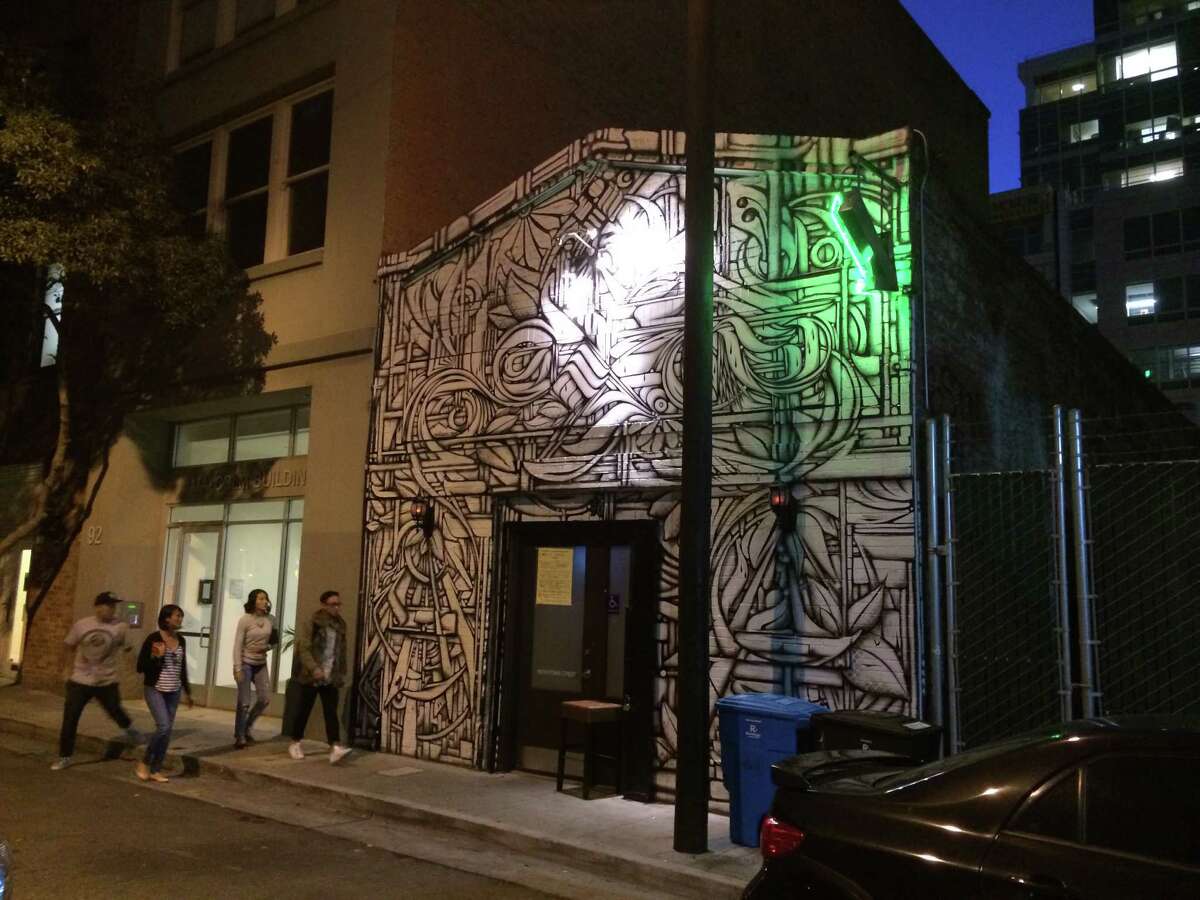 Built in 1913 for a blacksmith, the brick building tucked down an alleyway at 90 Natoma St. has seen several lives -- currently that of a popular bar, Natoma Cabana, with the front facade covered by a mural by Ian Ross.