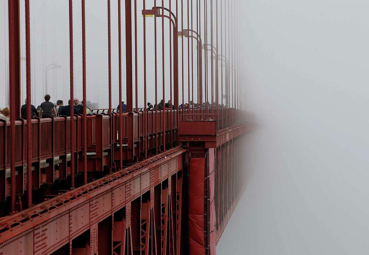 FILE -- The span of the Golden Gate Bridge disappears into the fog on June 27, 2014 in San Francisco, California. The Golden Gate Bridge district's board of directors voted unanimously to approve a $76 million funding package to build a net suicide barrier on the iconic span. Over 1,500 people committed suicide by jumping from the iconic bridge since it opened in 1937. 46 people jumped to their death in 2013. 
