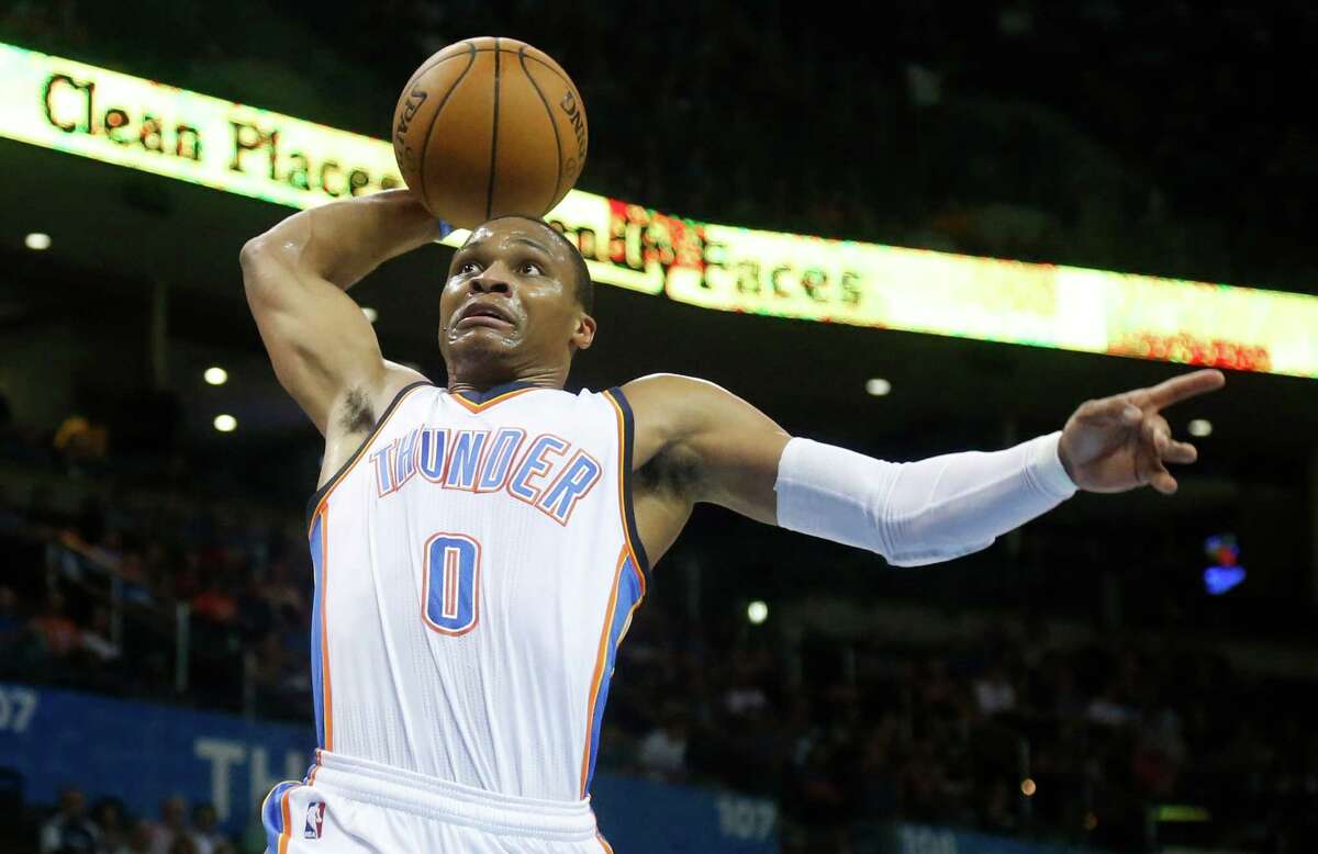 Oklahoma City Thunder guard Russell Westbrook goes up for a dunk in the first quarter of a pre-season NBA basketball game against the Utah Jazz in Oklahoma City, Tuesday, Oct. 21, 2014. (AP Photo/Sue Ogrocki)