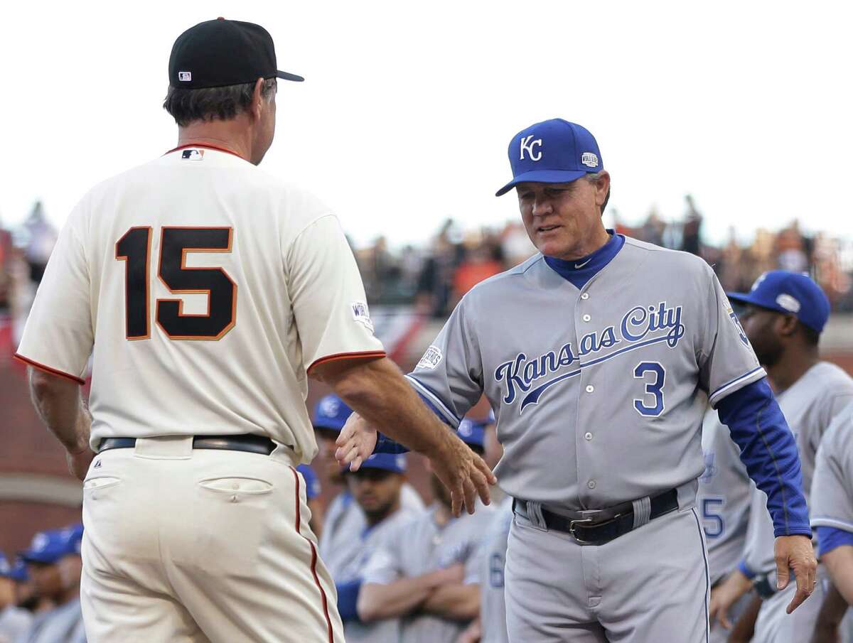 San Francisco Giants manager Bruce Bochy, left, shakes hands with Kansas City Royals manager Ned Yost before Game 3 of baseball's World Series Friday, Oct. 24, 2014, in San Francisco. (AP Photo/Matt Slocum)