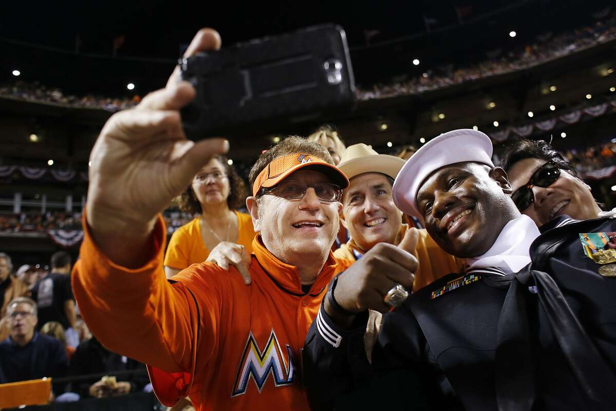 guy with marlins jersey behind home plate