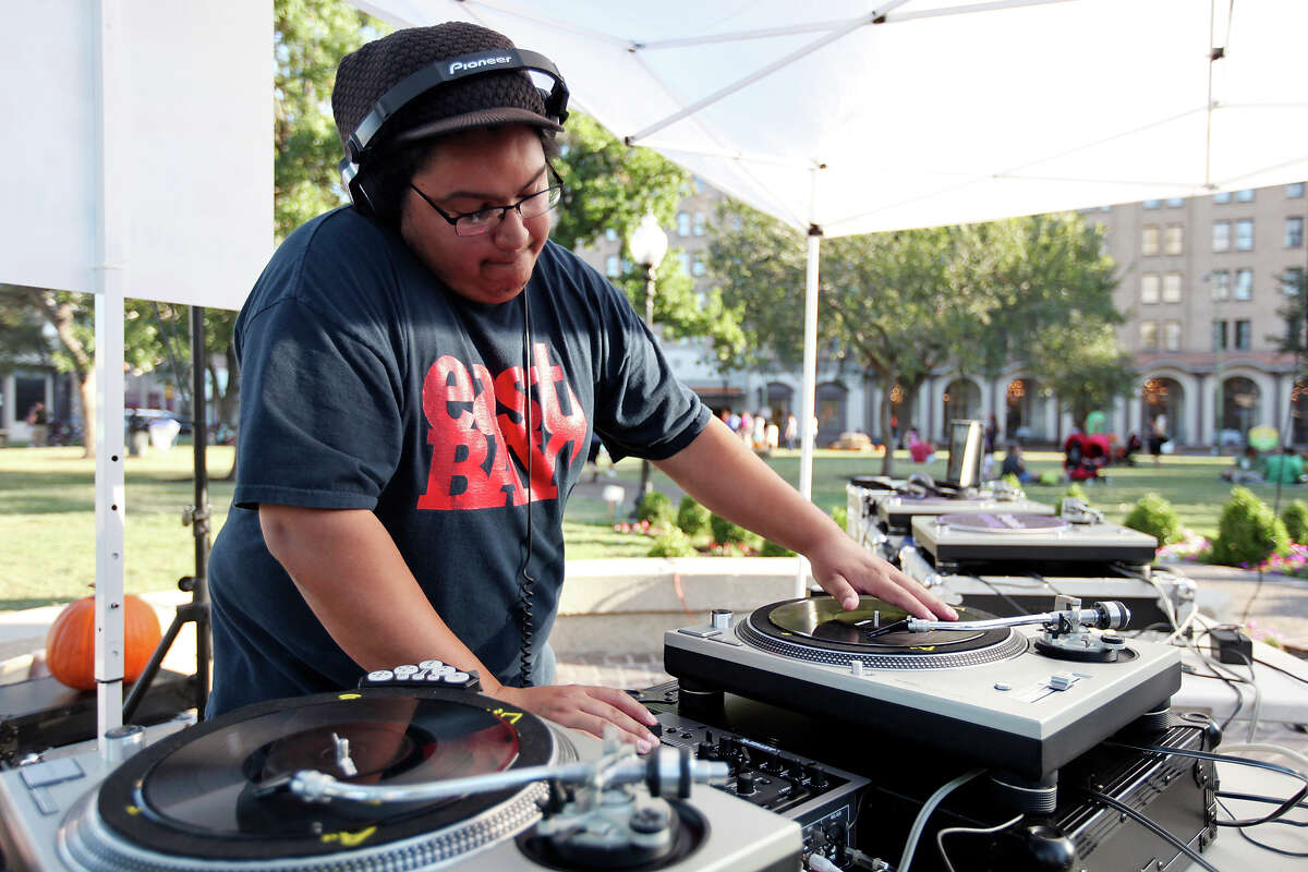 Isaiah "From Texas" Reyes, 28, deejays during the Fall Festival held Saturday Oct. 25, 2014 in Travis Park.
