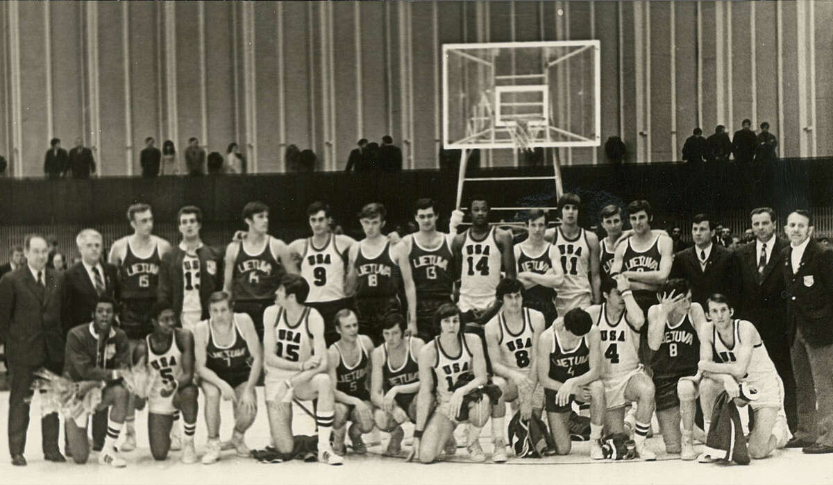 Members of the AAU All-Star team that toured Eastern Europe and the Soviet Union in 1972 gather with the Lithuania team after the Americans won their game. Popovich, the team's captain, is kneeling at far right.