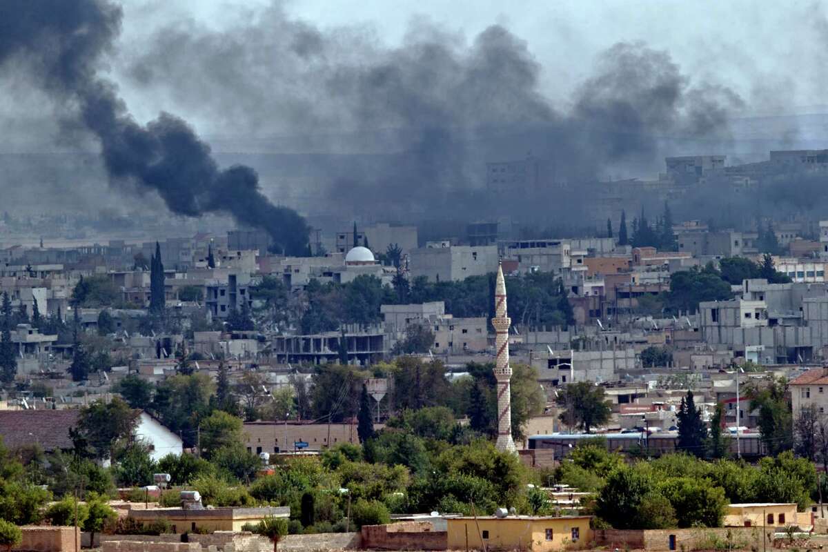 Smoke rises above the Syrian town of Kobani during fighting between Islamic State and Kurdish forces, seen from a hilltop on the outskirts of Suruc, Turkey, near the Turkey-Syria border, Sunday, Oct. 26, 2014. Kobani, also known as Ayn Arab, and its surrounding areas, has been under assault by extremists of the Islamic State group since mid-September and is being defended by Kurdish fighters.Latest from AP: Women on front lines in Syria, Iraq against IS