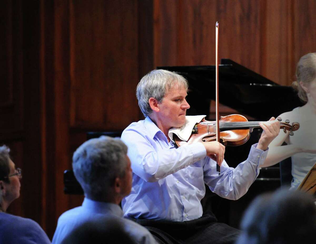 Violinist, Krystof Witek of the Chamber Players of the Greenwich Symphony Orchestra, during the "Sounds for a Summer Night" performance earlier in 2014. The group comes together again in November 2014 fora couple of concerts in Greenwich, Conn.