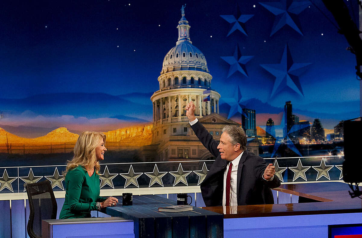“The Daily Show” host Jon Stewart interviews gubernatorial candidate Wendy Davis in Austin, where the show was taped Monday. Texas is “on its way” to being a blue state, Davis said.