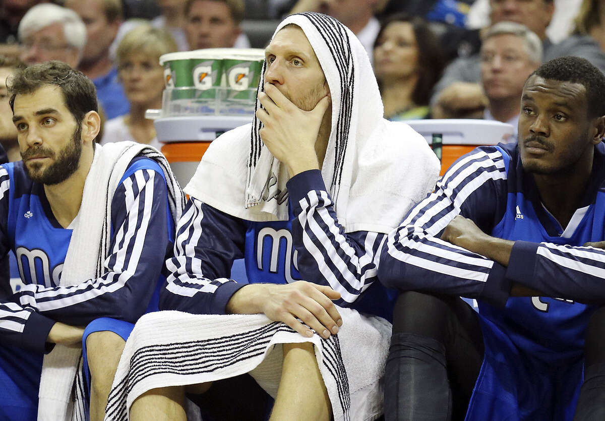 Dallas' Jose Calderon (from left), Dirk Nowitzki and Samuel Dalembert watched from the bench in May as the host Spurs closed out a seven-game victory in the first round of the playoffs. The Mavericks return to town tonight.