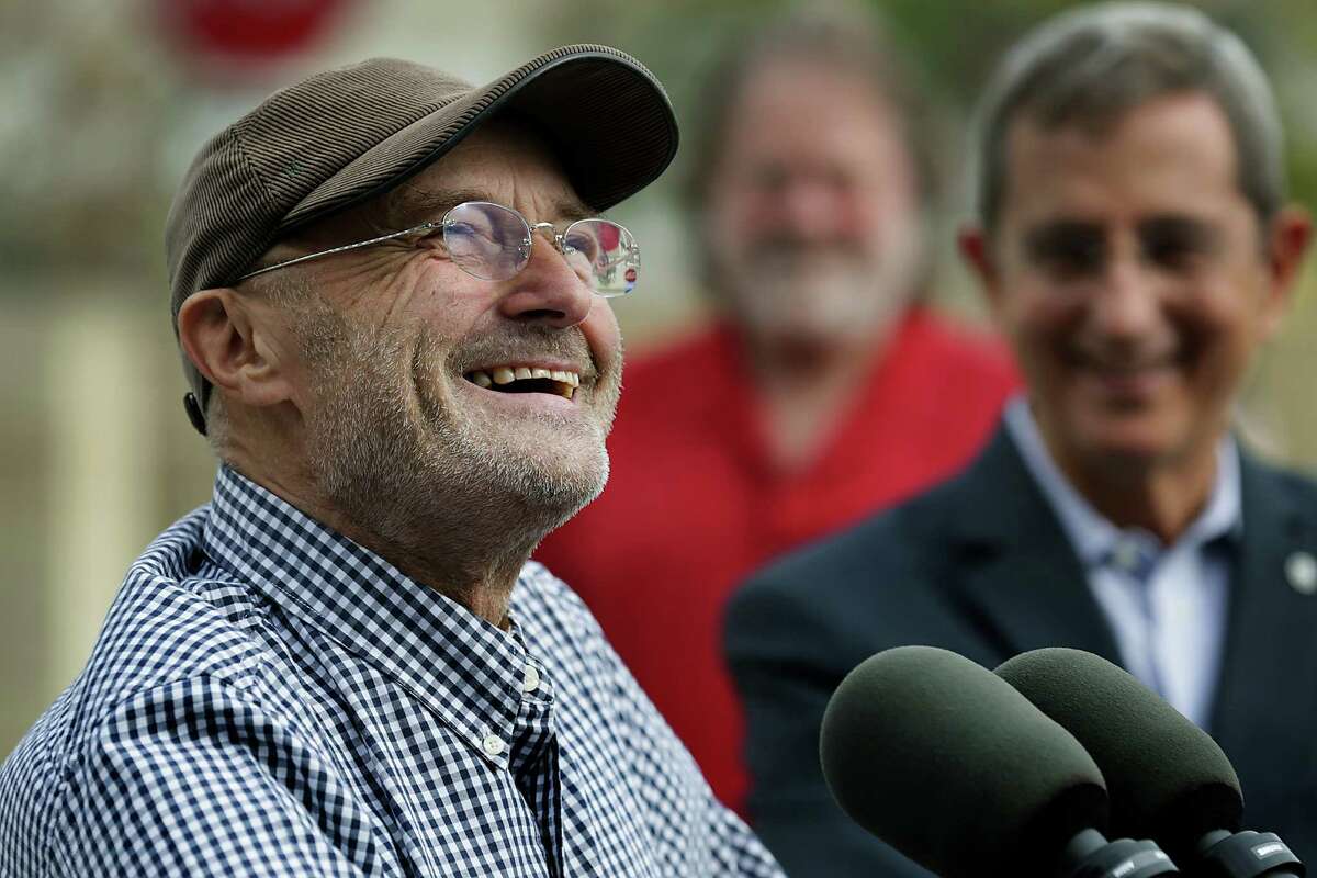 Phil Collins smiles as he speaks to the media with Texas Land Commissioner Jerry Patterson at right. Collns was donating Texas historical items to the Alamo. Tuesday Oct. 28, 2014.